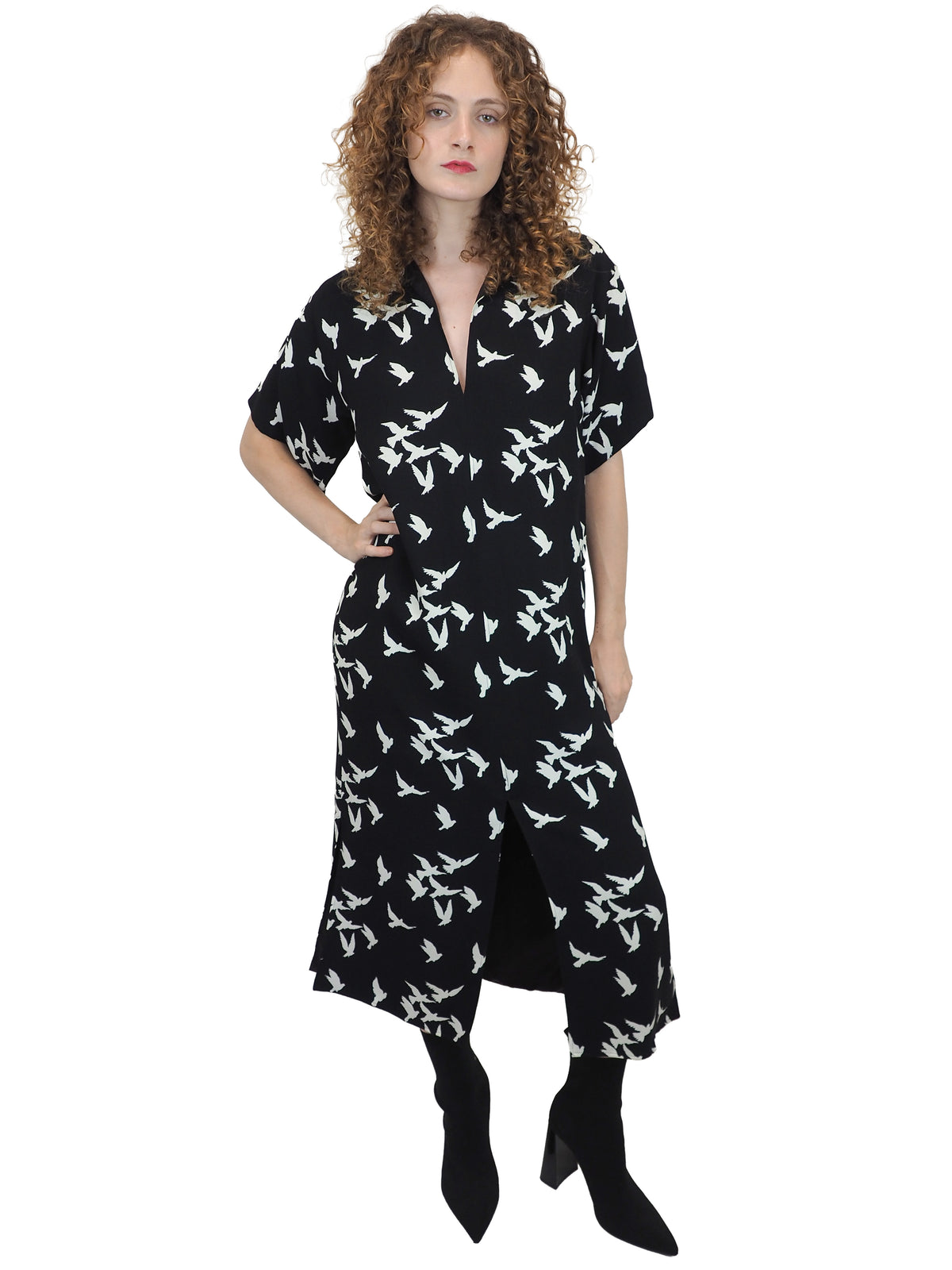 A vintage Yves Saint Laurent YSL 1970's black short-sleeve midi dress with a white bird pattern
