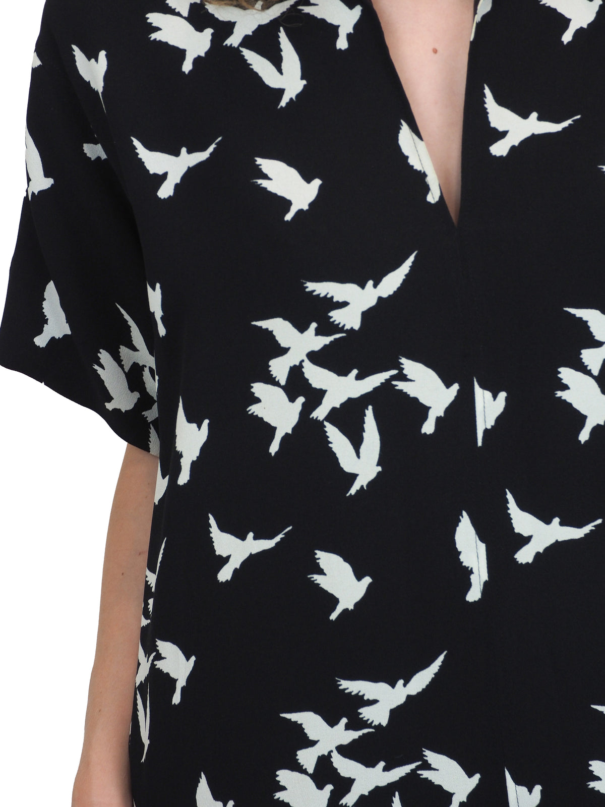 A vintage Yves Saint Laurent YSL 1970's black short-sleeve midi dress with a white bird pattern
