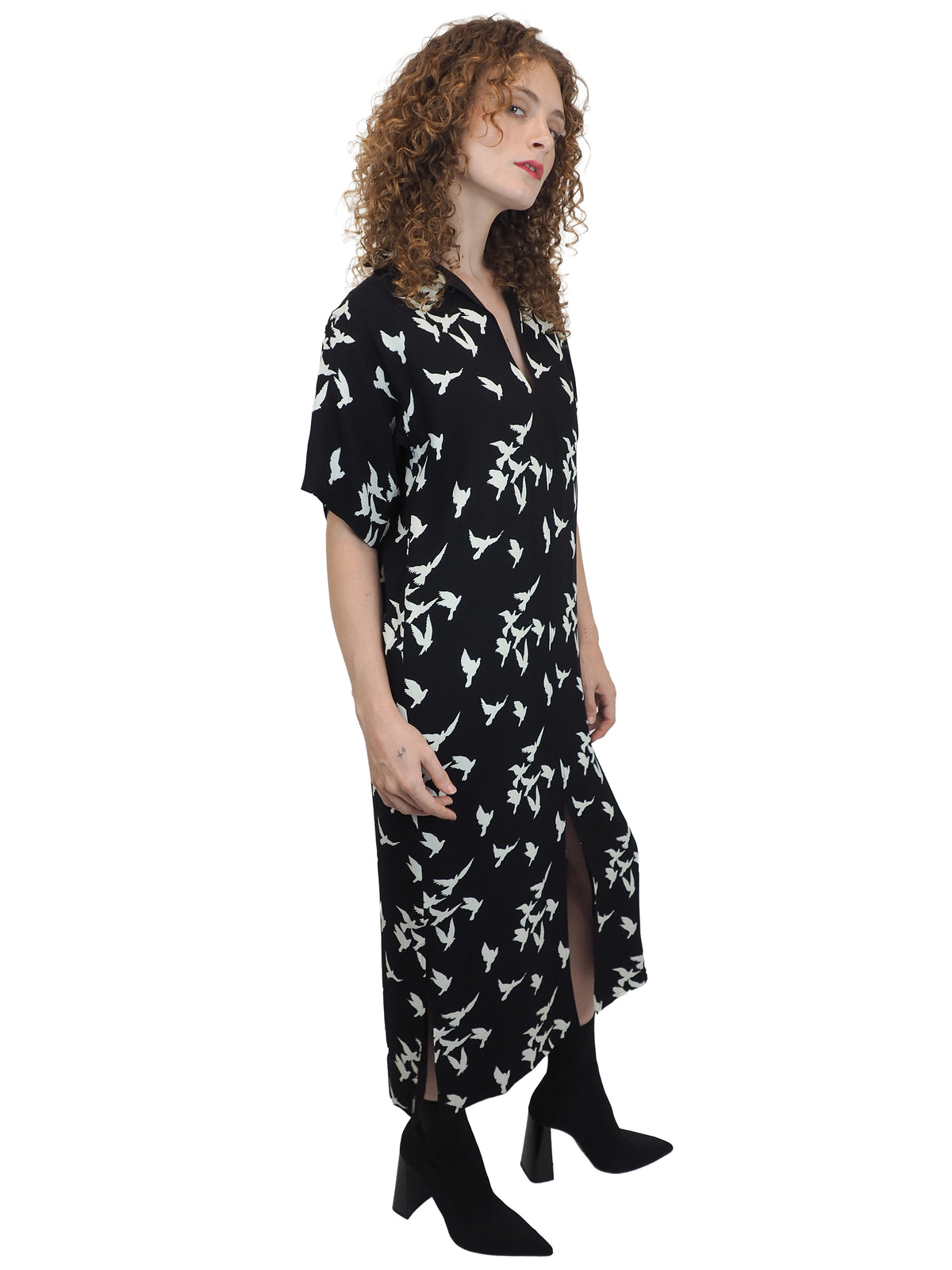 A vintage Yves Saint Laurent YSL 1970's black short-sleeve midi dress with a white bird pattern