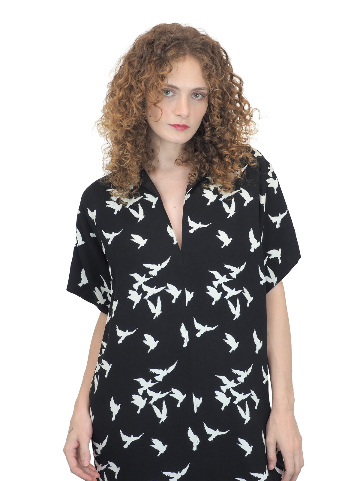 A vintage Yves Saint Laurent YSL 1970's black short-sleeve midi dress with a white bird pattern