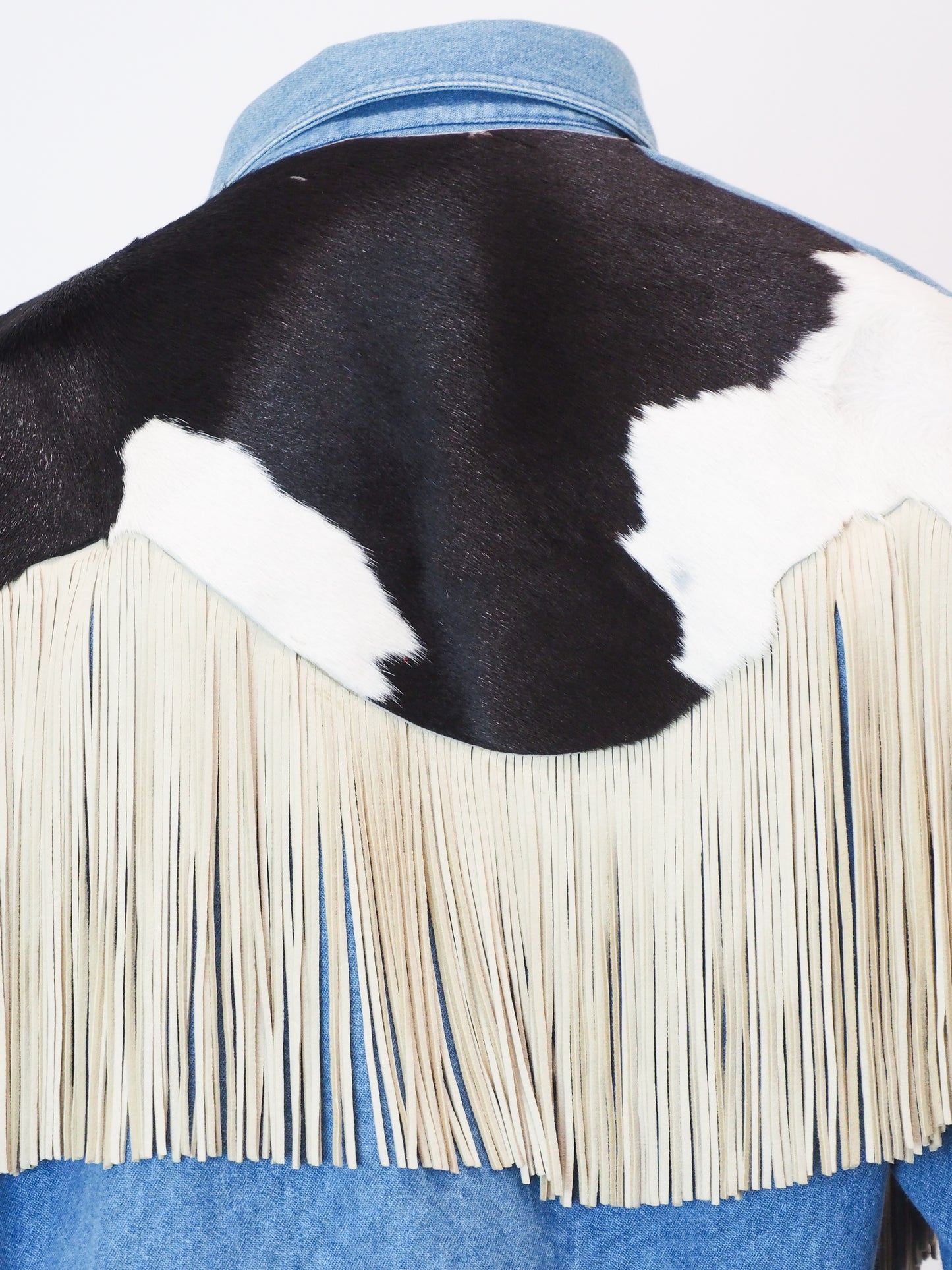 Cowhide leather jacket with fringes and denim collar