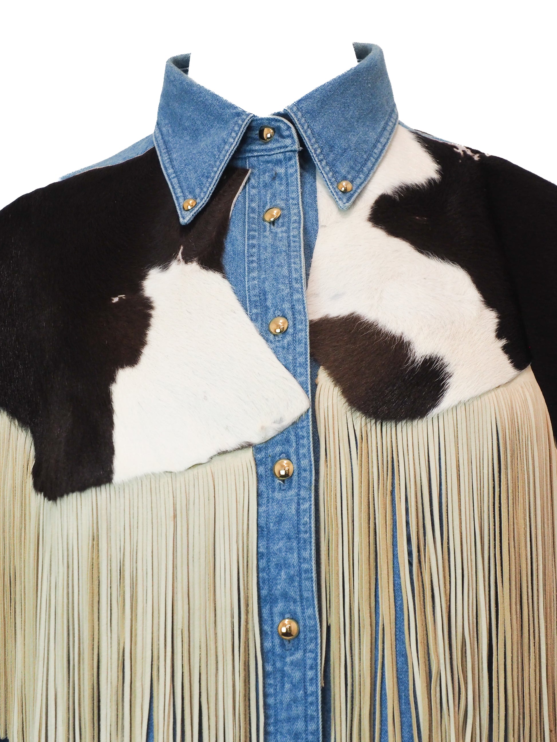 Cowhide leather shirt with denim collar and fringes on a white background