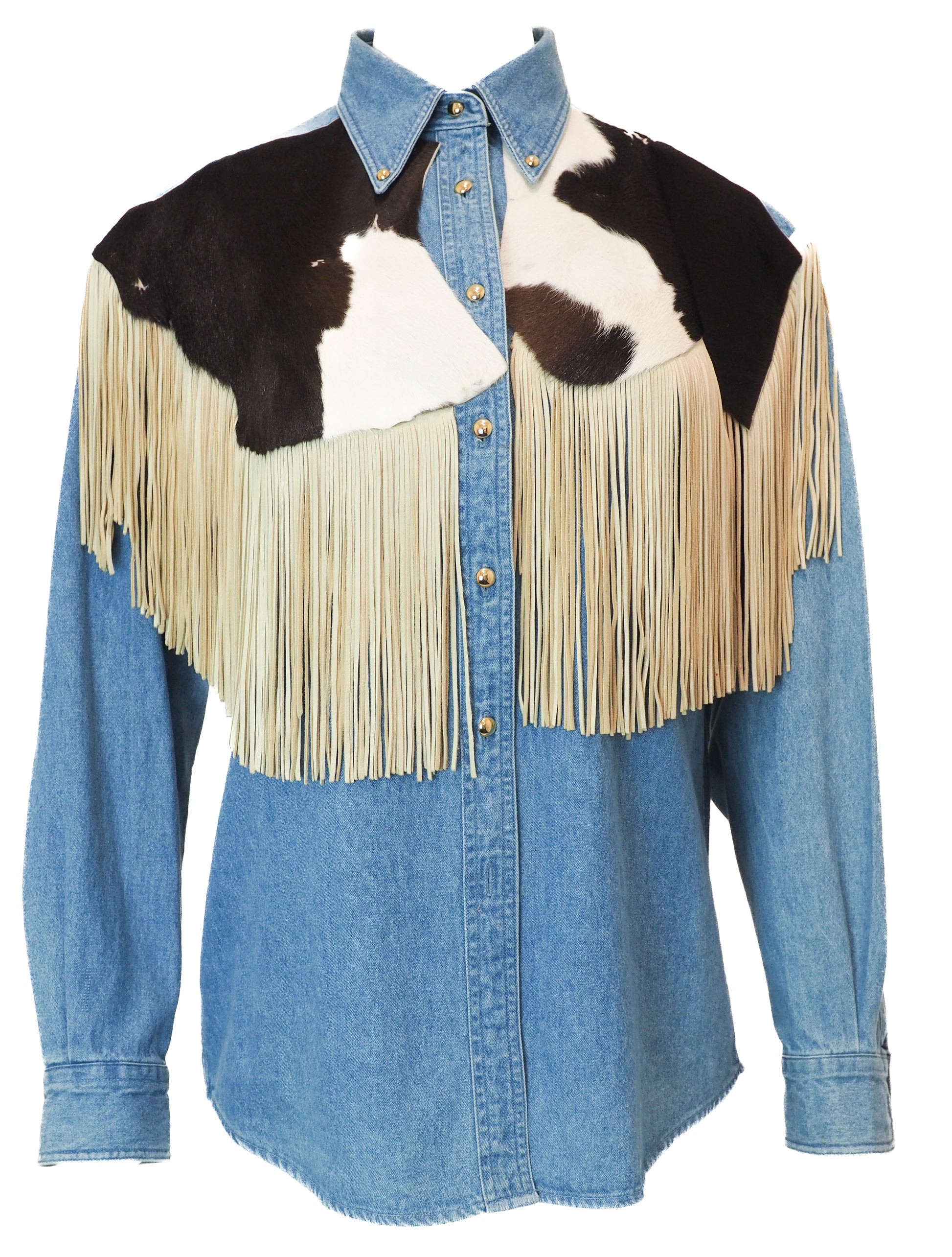 Blue denim shirt with cowhide leather and fringe accents on a white background
