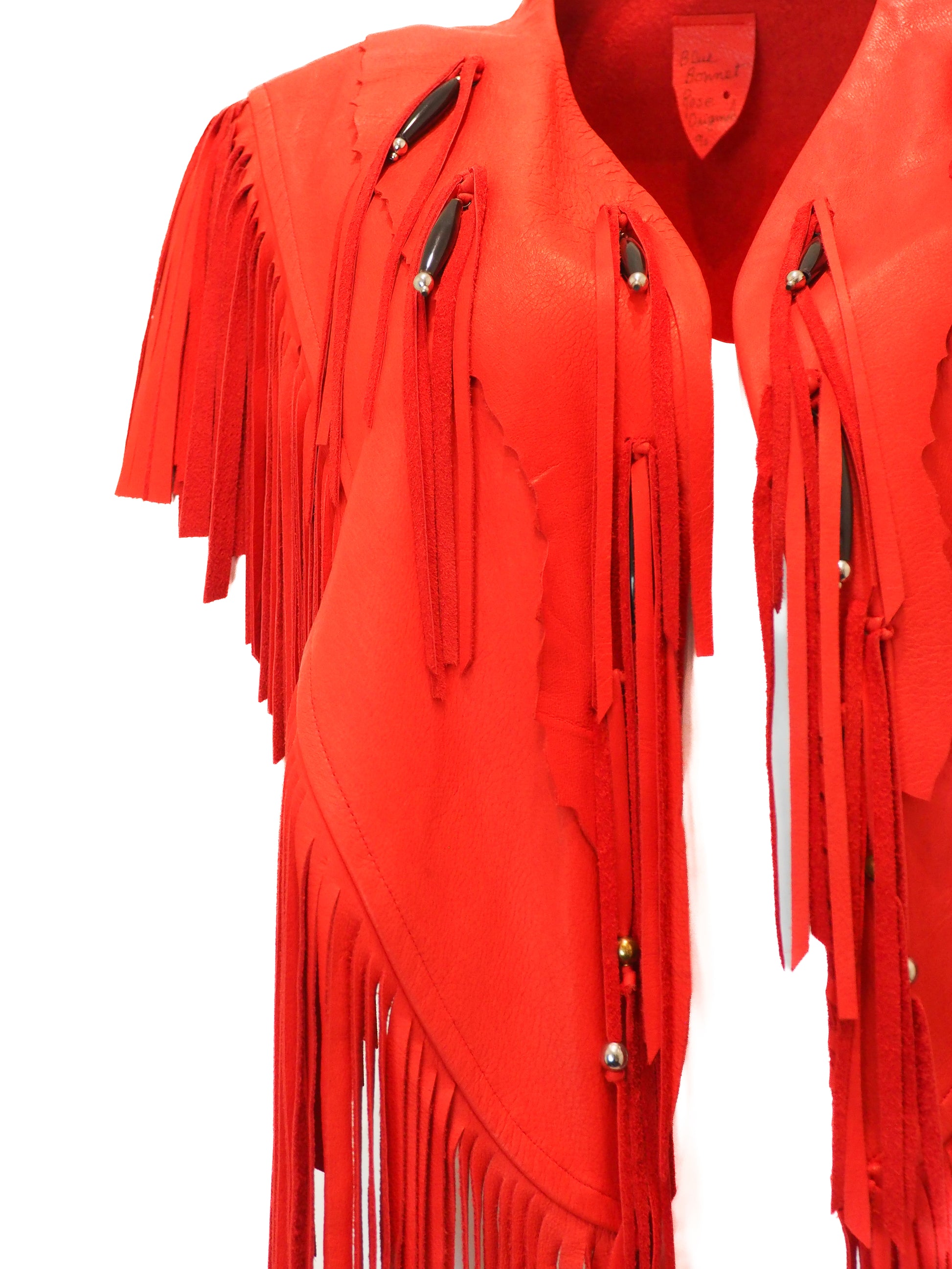 Red fringed garment on a white background