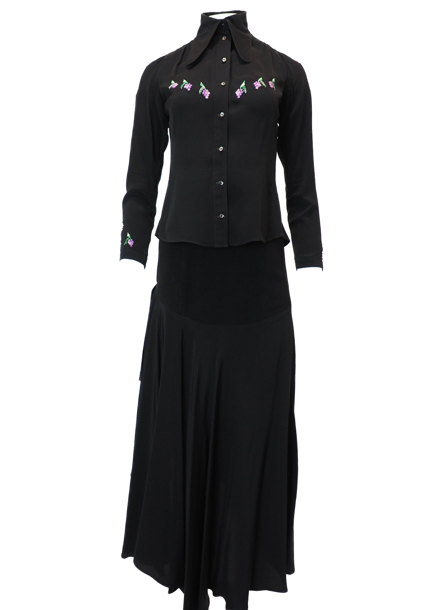 Black blouse with floral embroidery and a matching black skirt on a white background