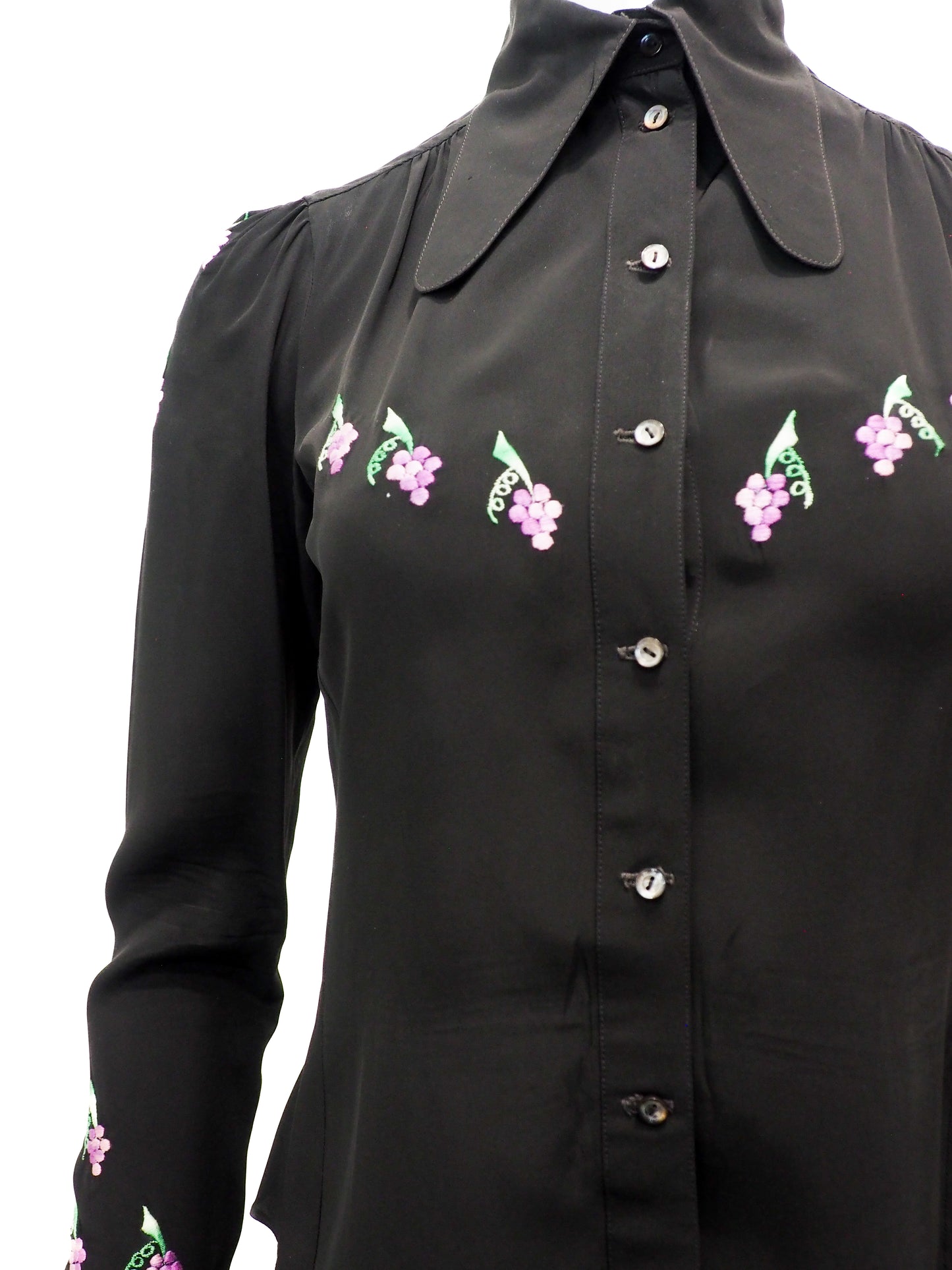 Black blouse with floral embroidery on a white background