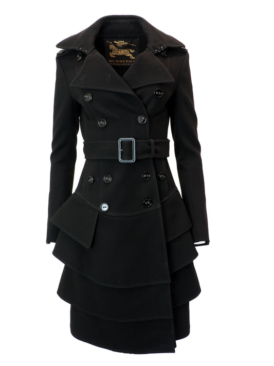 Black coat with a belt and layered skirt design on a white background