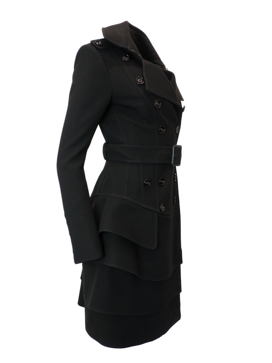 Black coat with a ruffled skirt on a white background