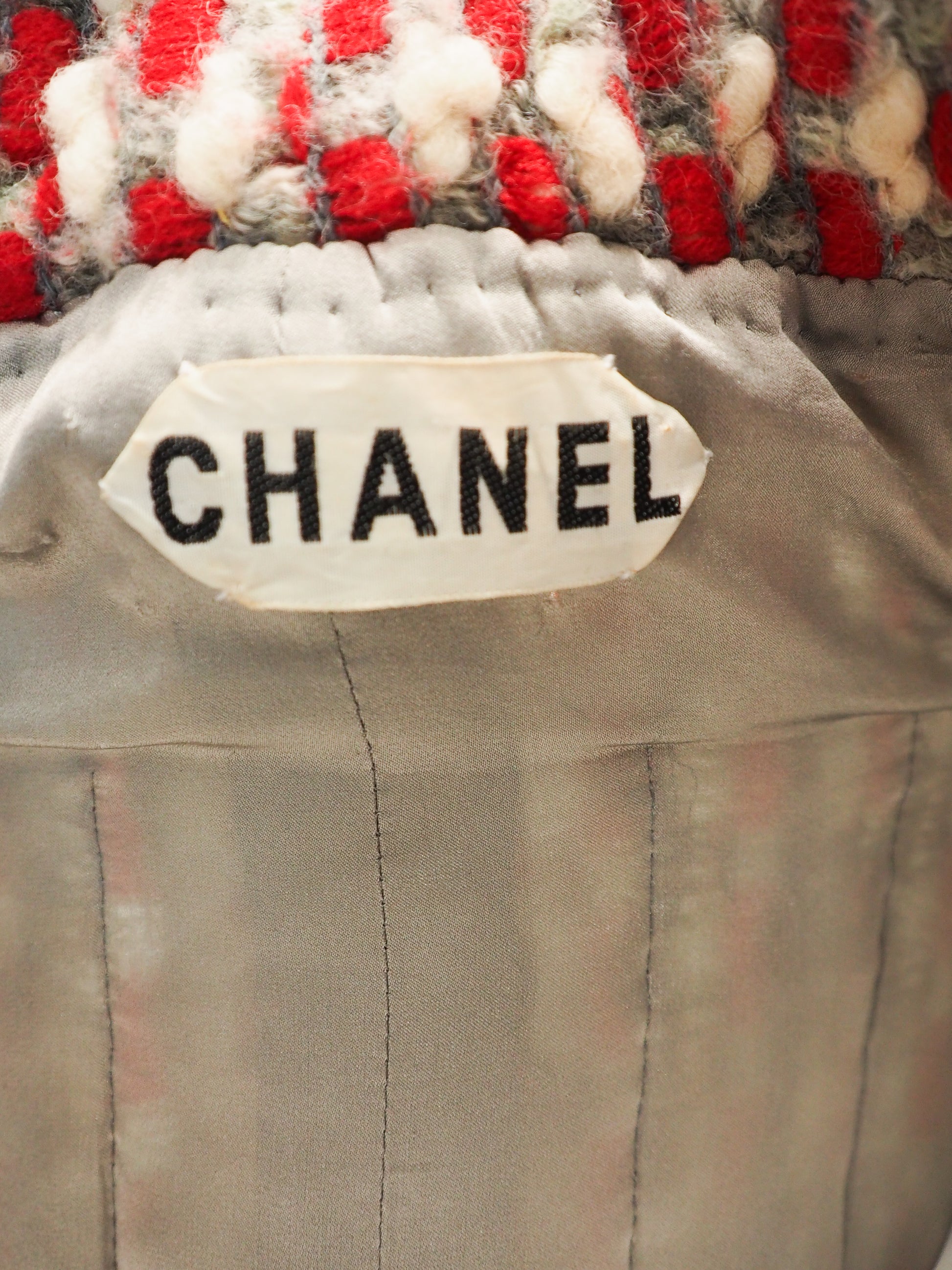 Close-up of a Chanel label on a textured fabric background