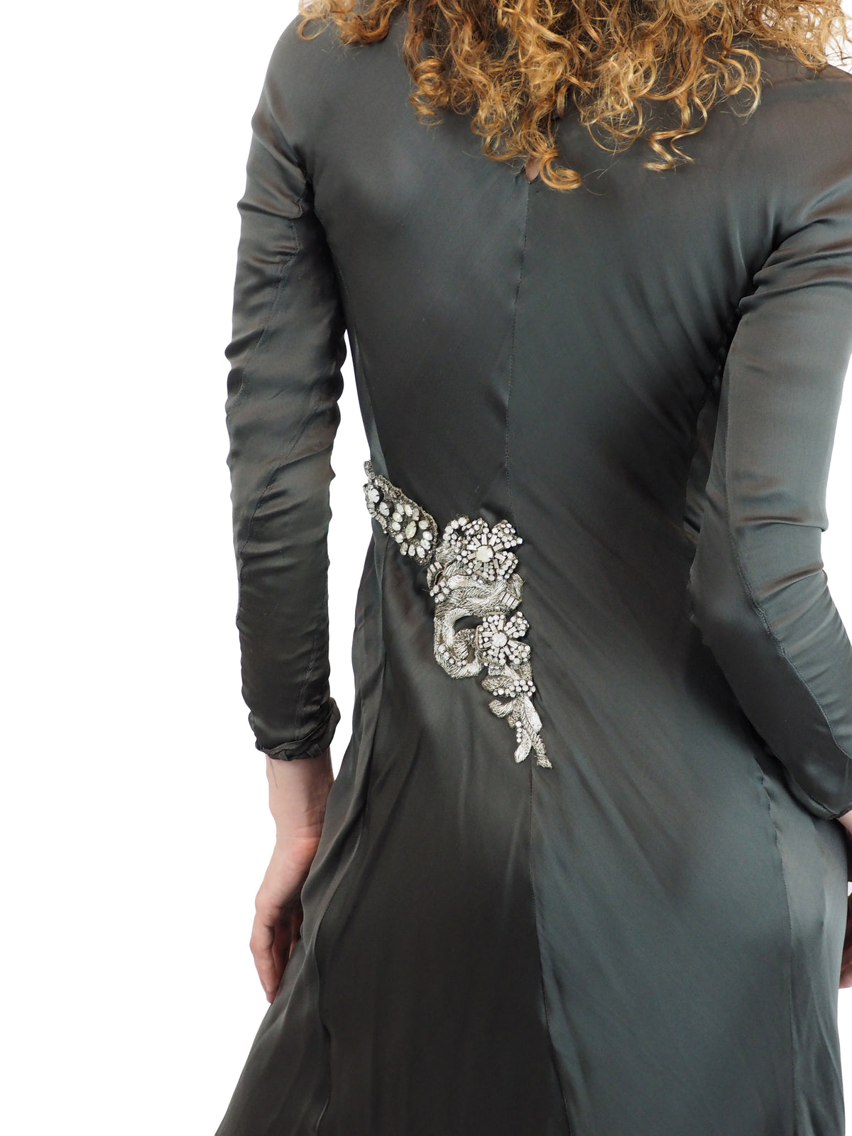 A vintage Alberta Ferretti floor-length green turtleneck gown with long sleeves and silver embellished details on the chest and waist