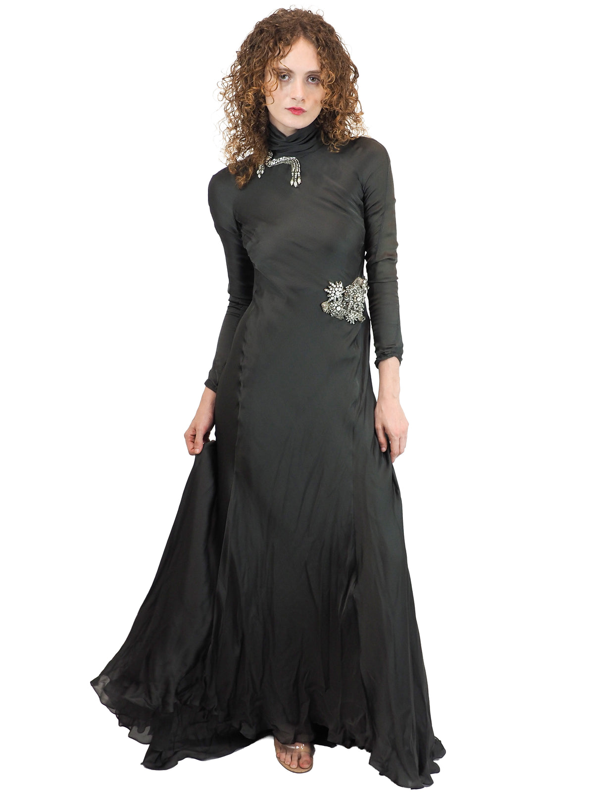 A vintage Alberta Ferretti floor-length green turtleneck gown with long sleeves and silver embellished details on the chest and waist