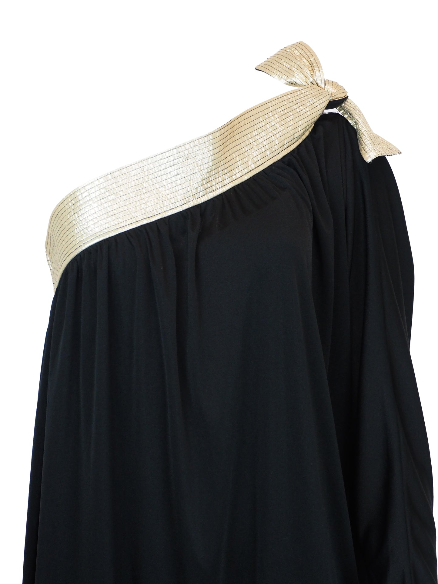 A vintage bill Tice black one-shoulder maxi dress with a wide, textured gold shoulder strap and a matching gold bow detail at the neckline