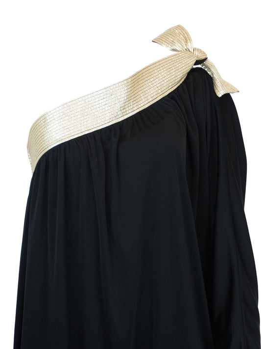 A vintage bill Tice black one-shoulder maxi dress with a wide, textured gold shoulder strap and a matching gold bow detail at the neckline
