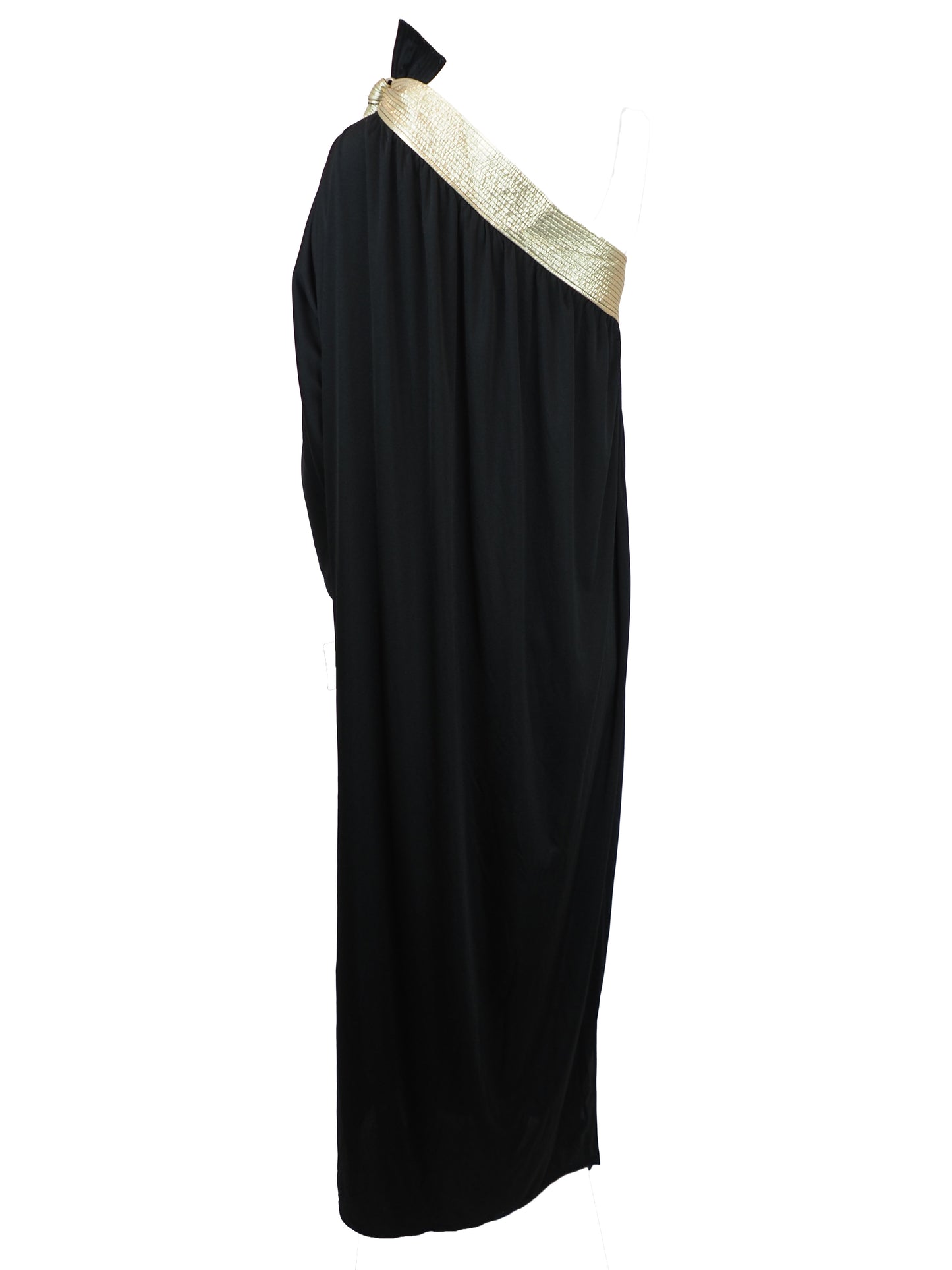 A vintage bill Tice black one-shoulder maxi dress with a wide, textured gold shoulder strap and a matching gold bow detail at the neckline