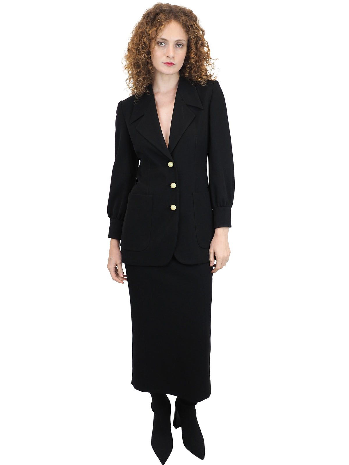 A vintage moschino black two-piece suit with marble buttons on the blazer and a long pencil skirt