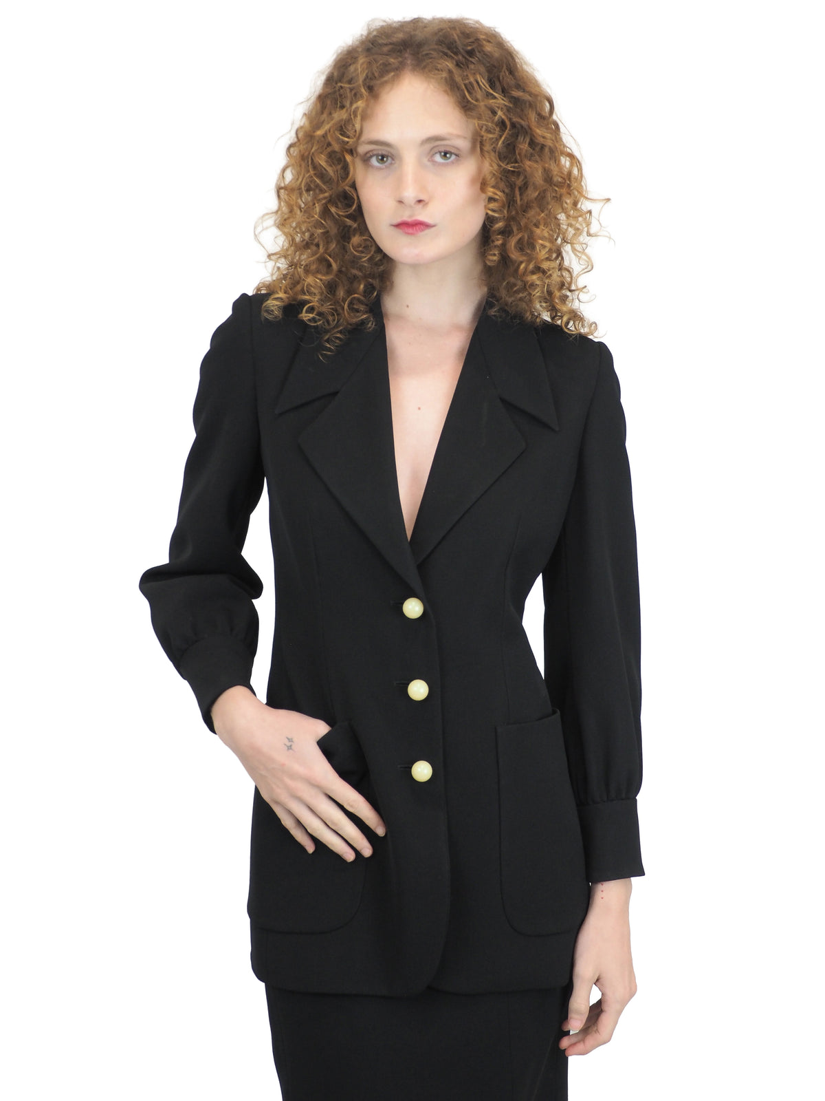 A vintage moschino black two-piece suit with marble buttons on the blazer and a long pencil skirt