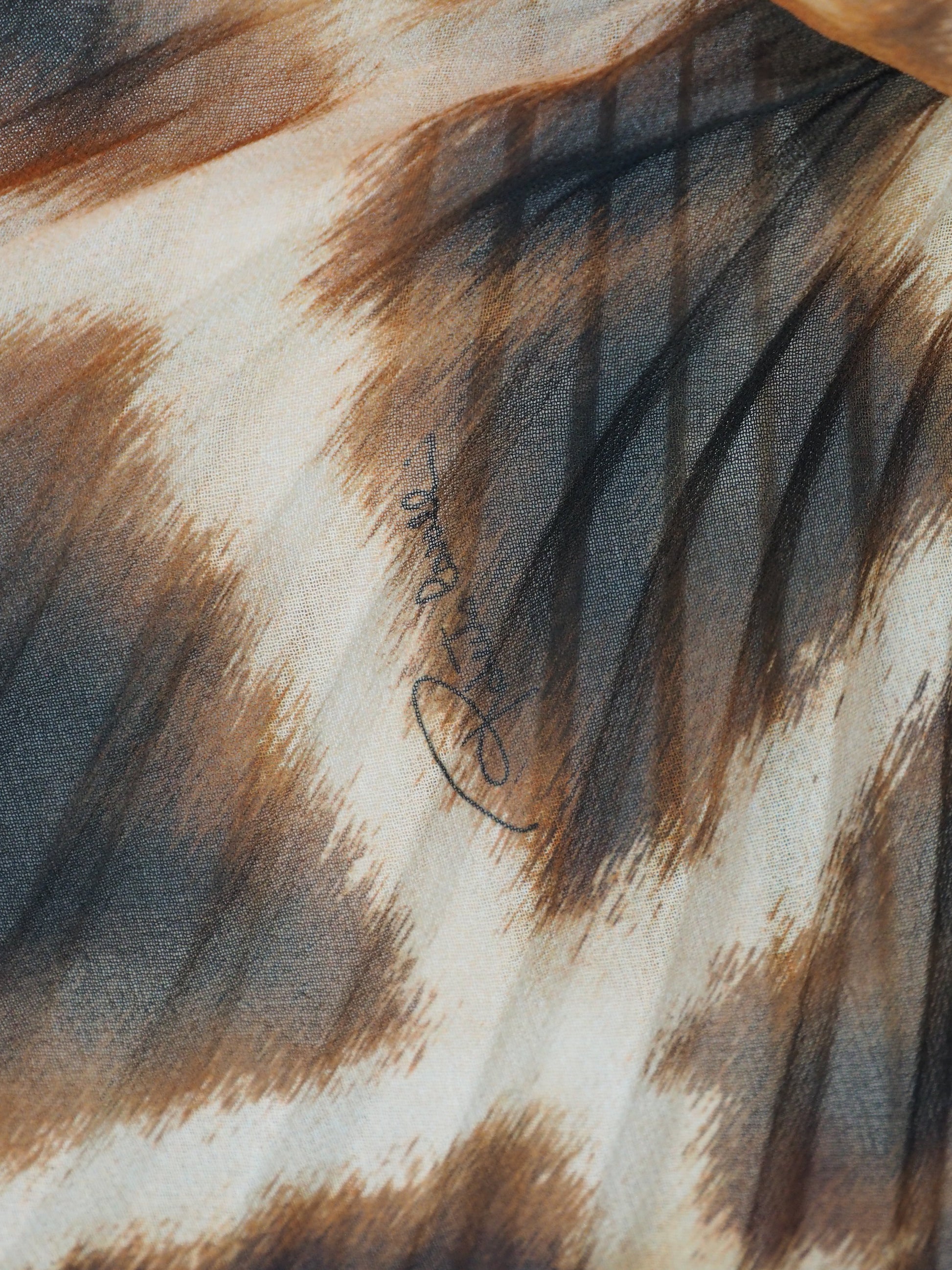 A vintage Roberto cavalli 2021 pleated midi skirt featuring an abstract leopard print pattern in brown, black, and beige