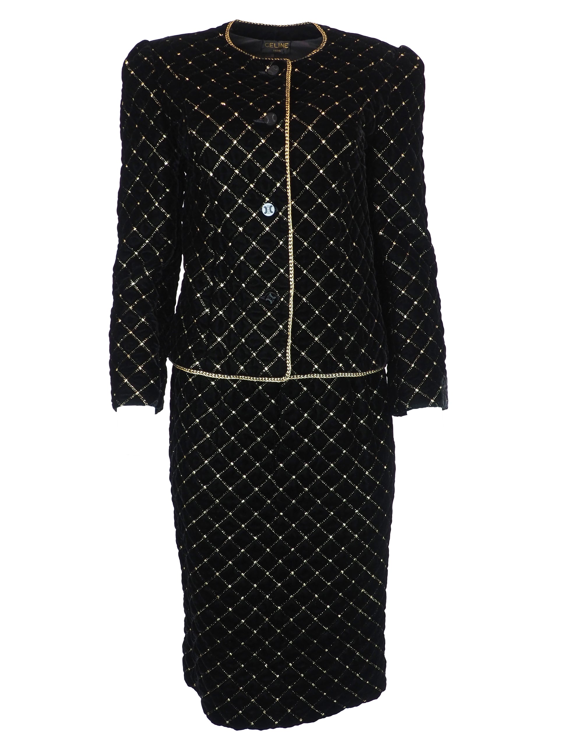A vintage Celine black velvet two-piece suit set consisting of a cropped jacket and a matching pencil skirt, both decorated with a gold diamond lattice pattern and gold trim