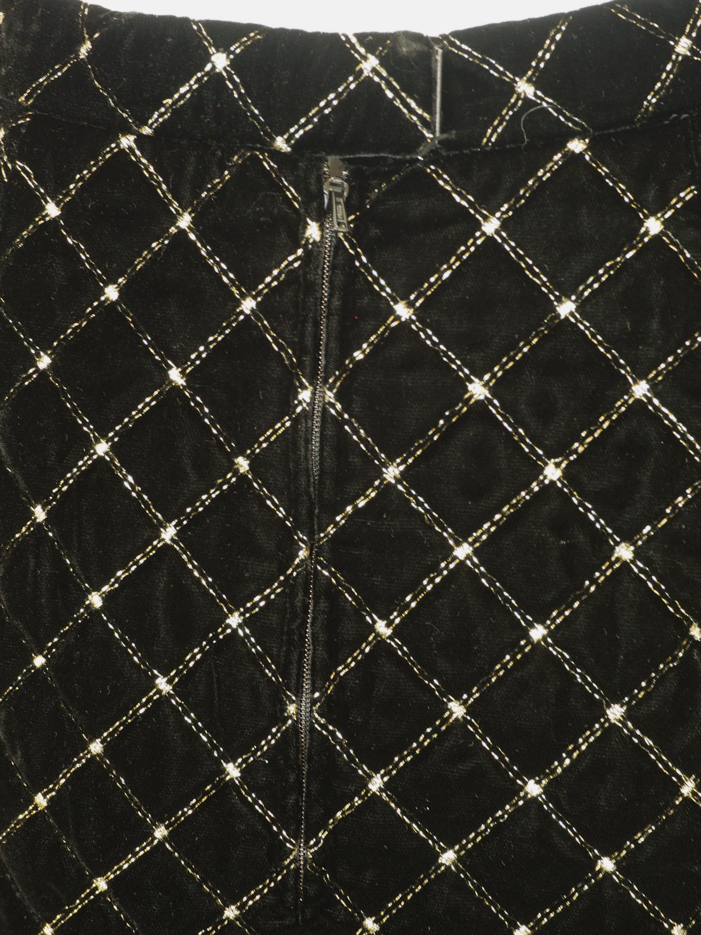 A vintage Celine black velvet two-piece suit set consisting of a cropped jacket and a matching pencil skirt, both decorated with a gold diamond lattice pattern and gold trim