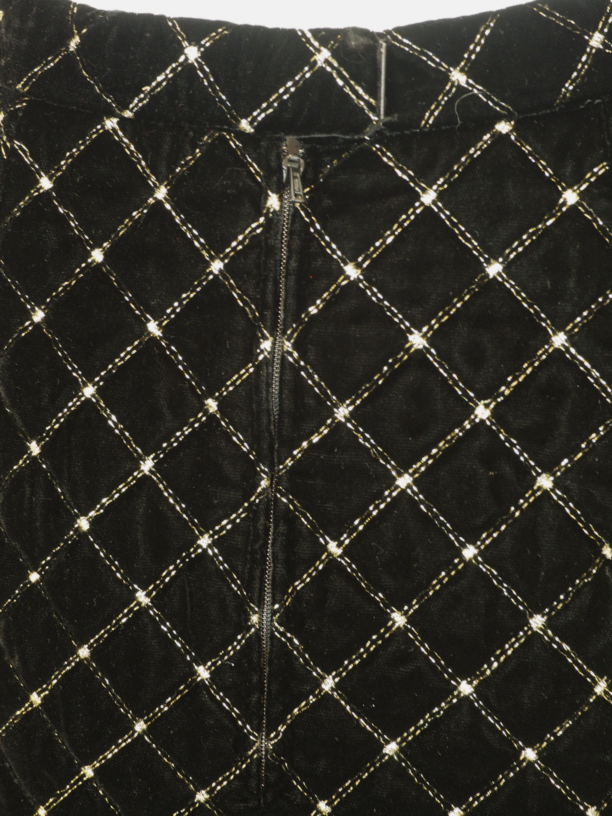 A vintage Celine black velvet two-piece suit set consisting of a cropped jacket and a matching pencil skirt, both decorated with a gold diamond lattice pattern and gold trim
