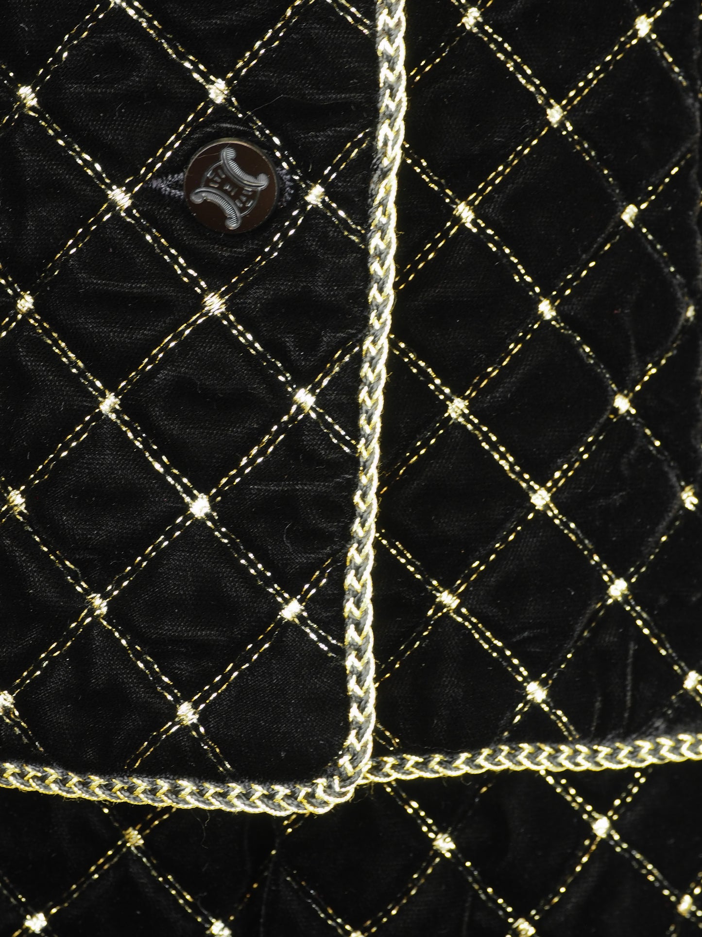 A vintage Celine black velvet two-piece suit set consisting of a cropped jacket and a matching pencil skirt, both decorated with a gold diamond lattice pattern and gold trim