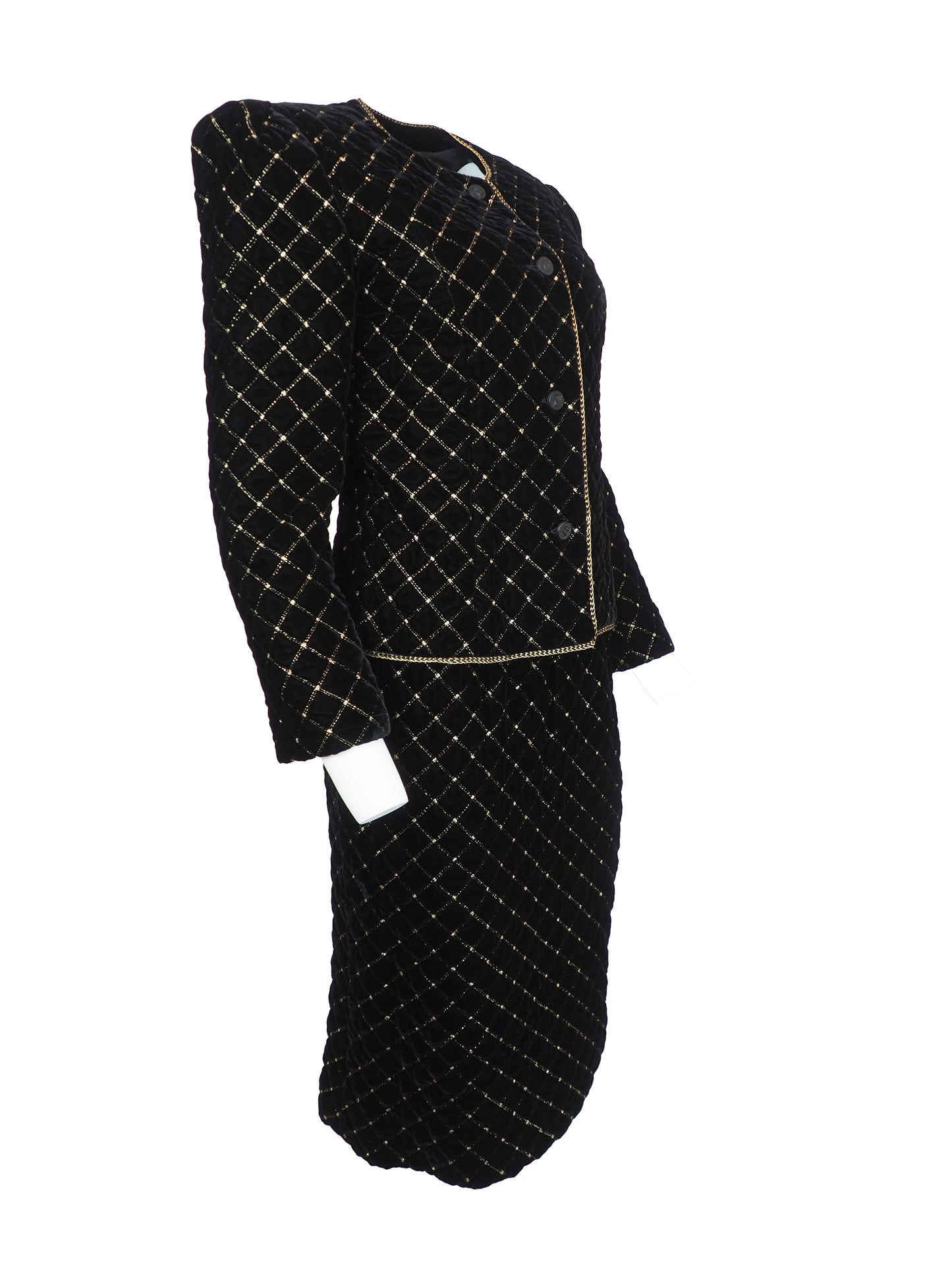 A vintage Celine black velvet two-piece suit set consisting of a cropped jacket and a matching pencil skirt, both decorated with a gold diamond lattice pattern and gold trim