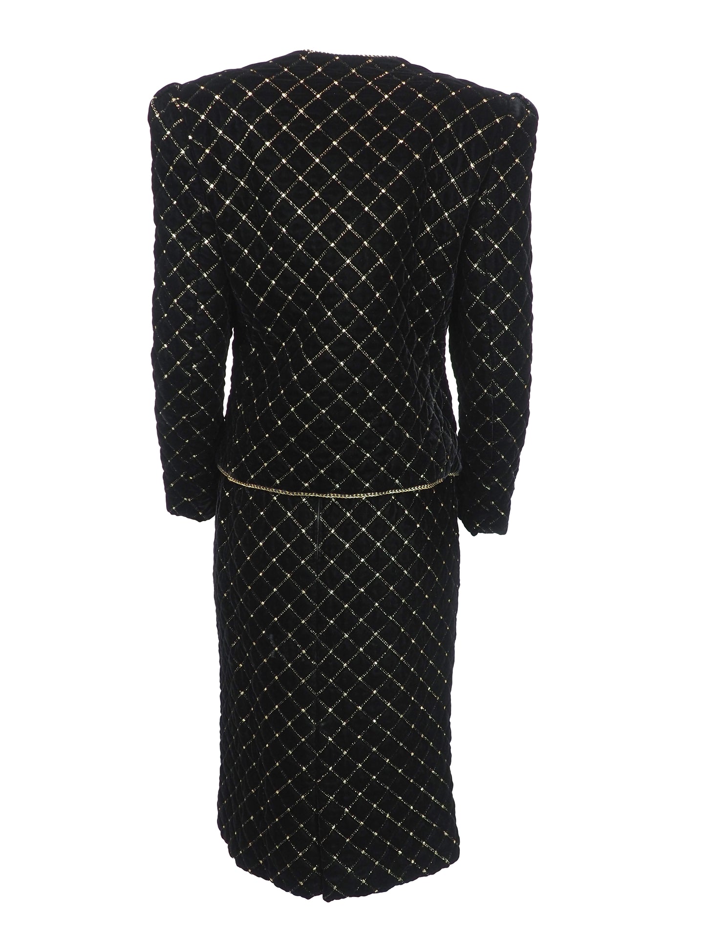 A vintage Celine black velvet two-piece suit set consisting of a cropped jacket and a matching pencil skirt, both decorated with a gold diamond lattice pattern and gold trim