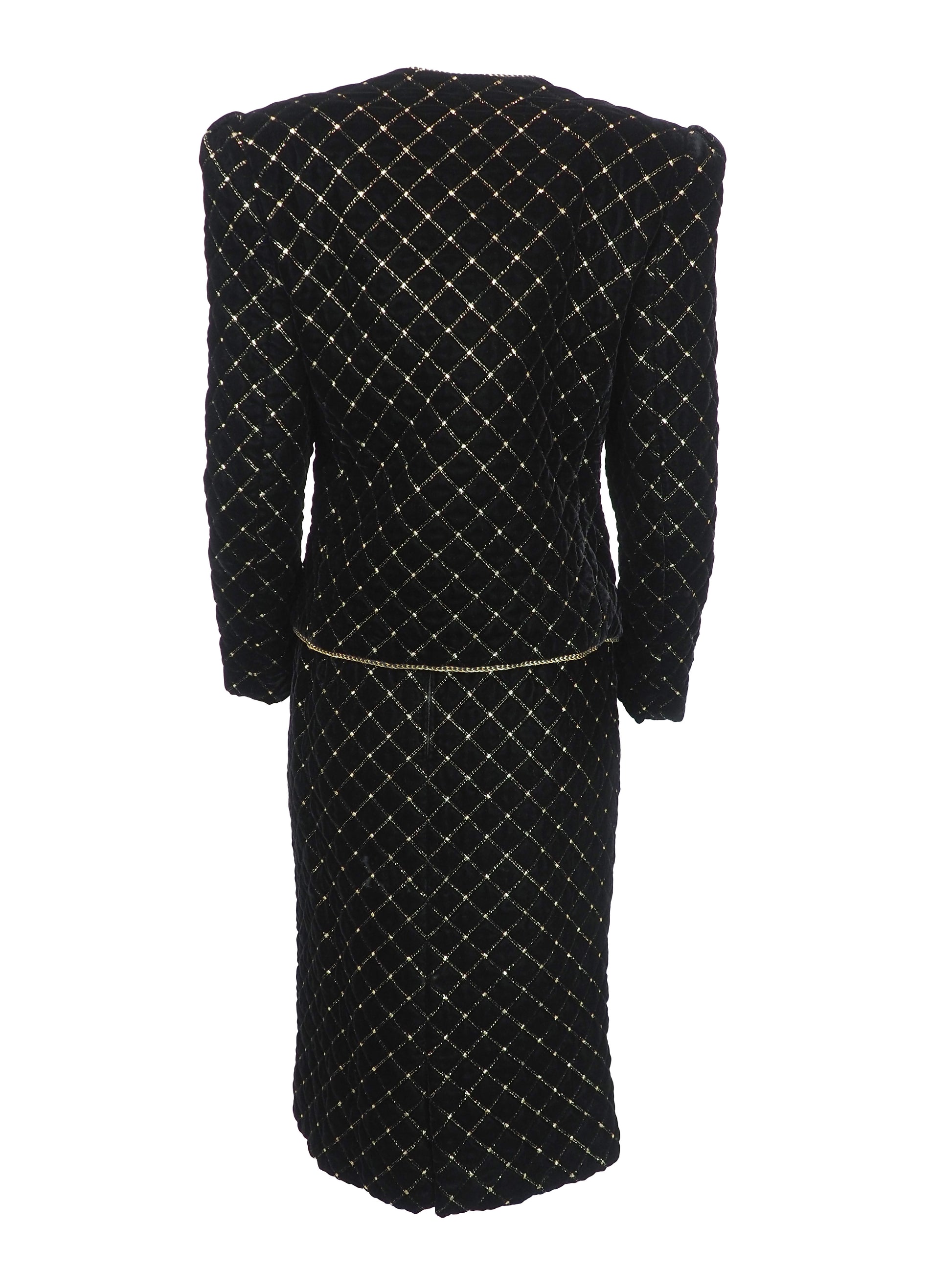 A vintage Celine black velvet two-piece suit set consisting of a cropped jacket and a matching pencil skirt, both decorated with a gold diamond lattice pattern and gold trim