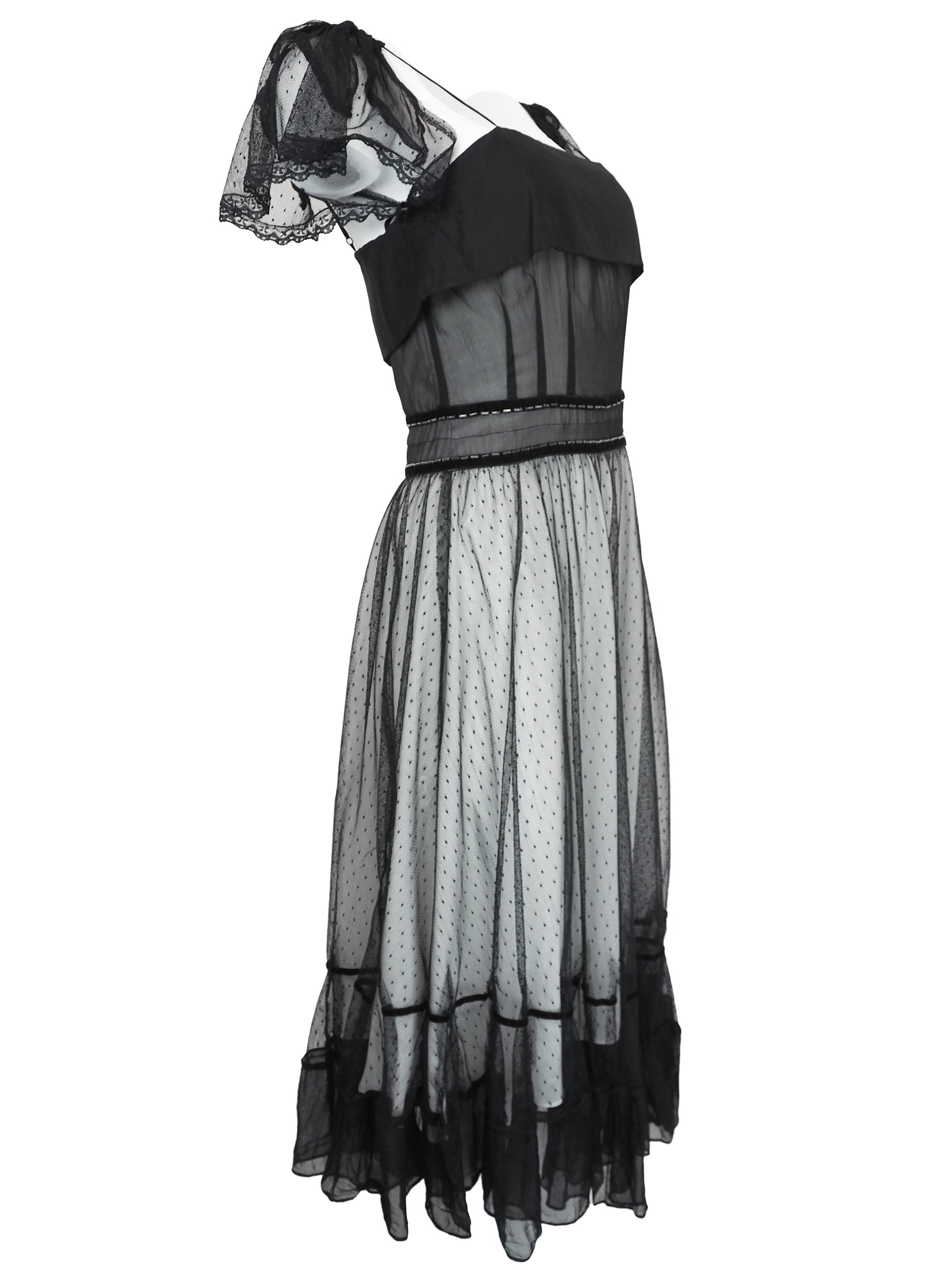 A vintage Chloe 2005 black sheer mesh dress with a solid black off-the-shoulder yoke, a polka-dotted tulle skirt, and ruffled trim details