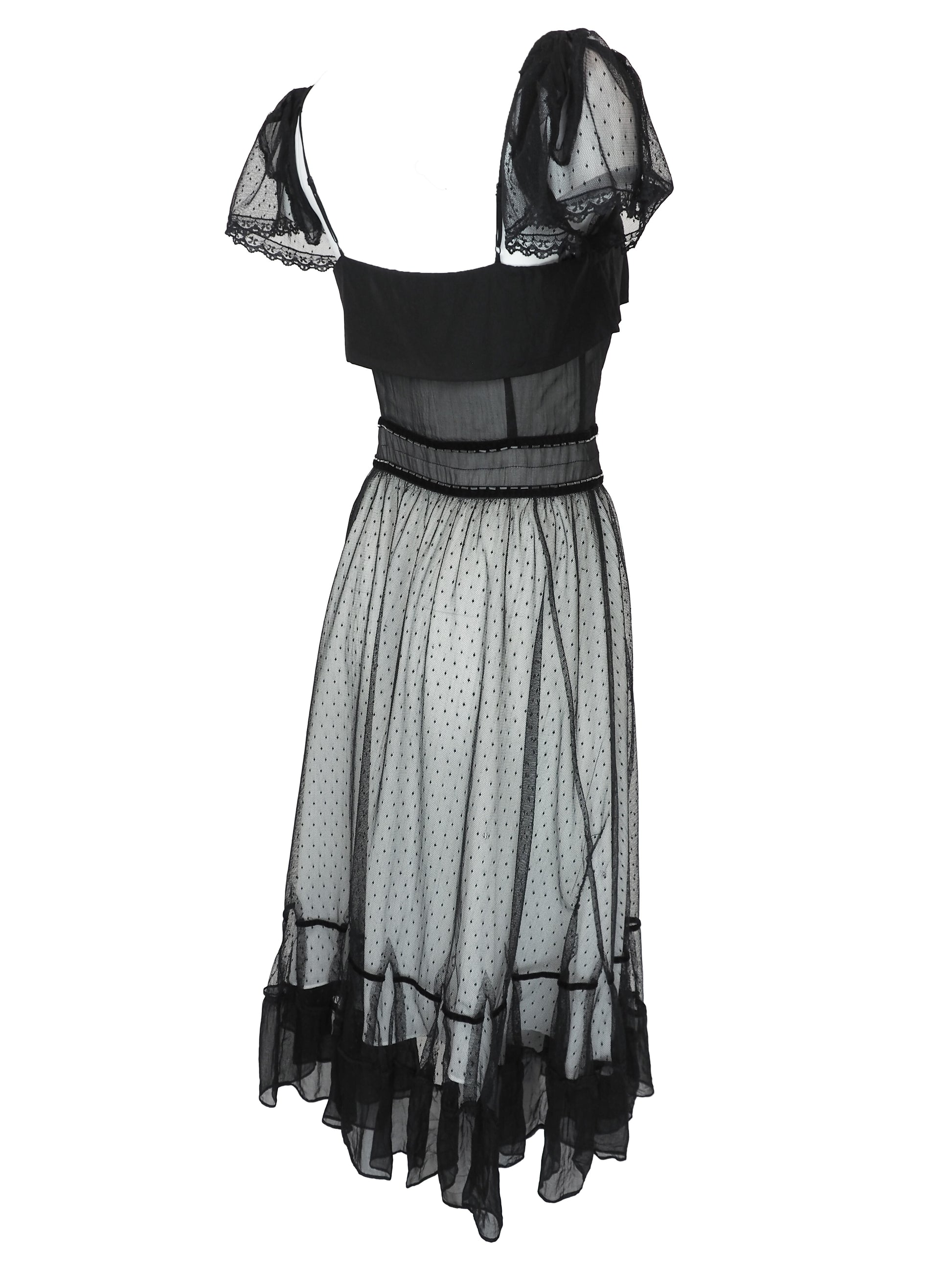 A vintage Chloe 2005 black sheer mesh dress with a solid black off-the-shoulder yoke, a polka-dotted tulle skirt, and ruffled trim details