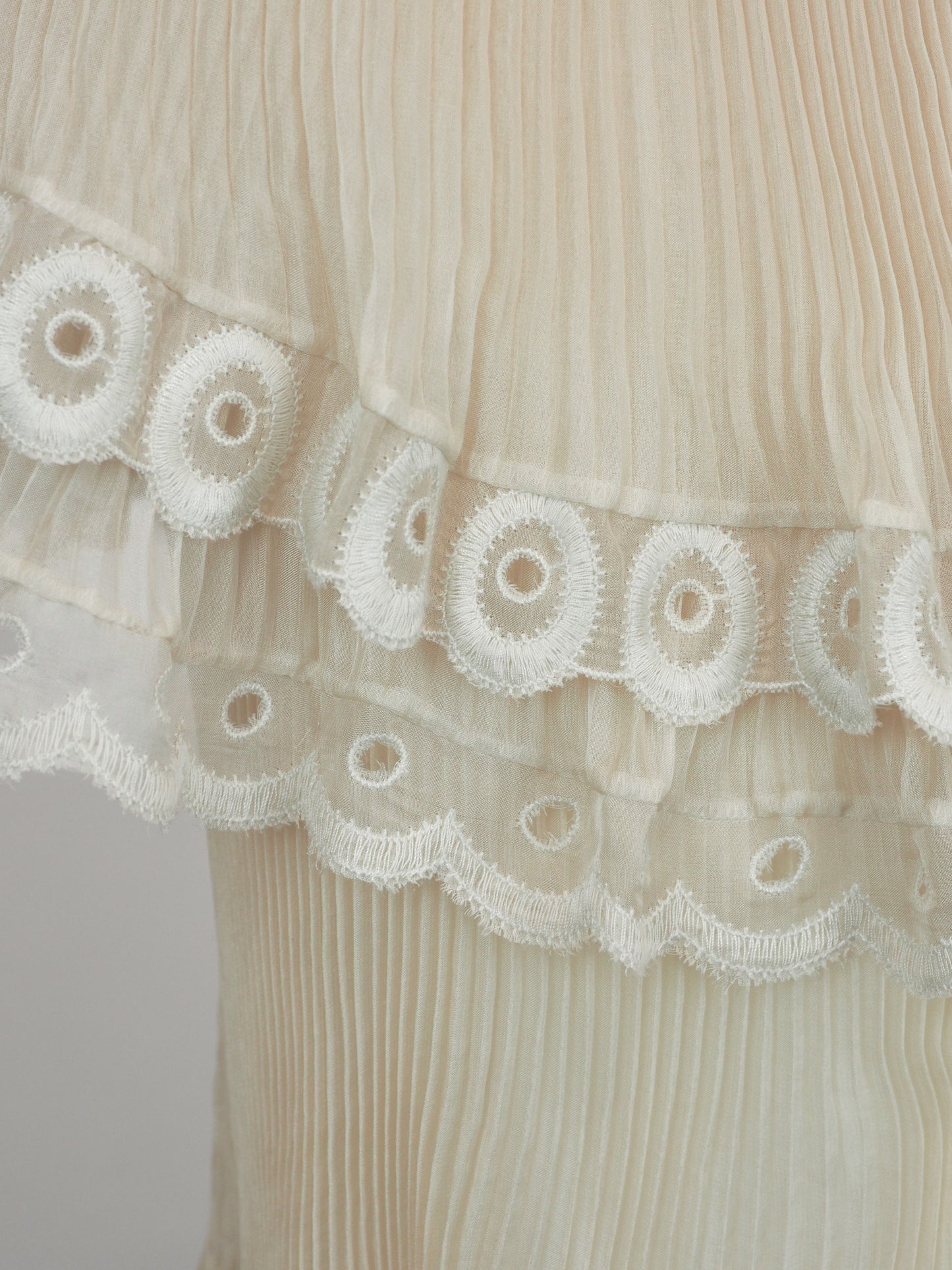A vintage Chloe runway cream-colored tiered lace dress with ruffled eyelet trim and off-the-shoulder sleeves