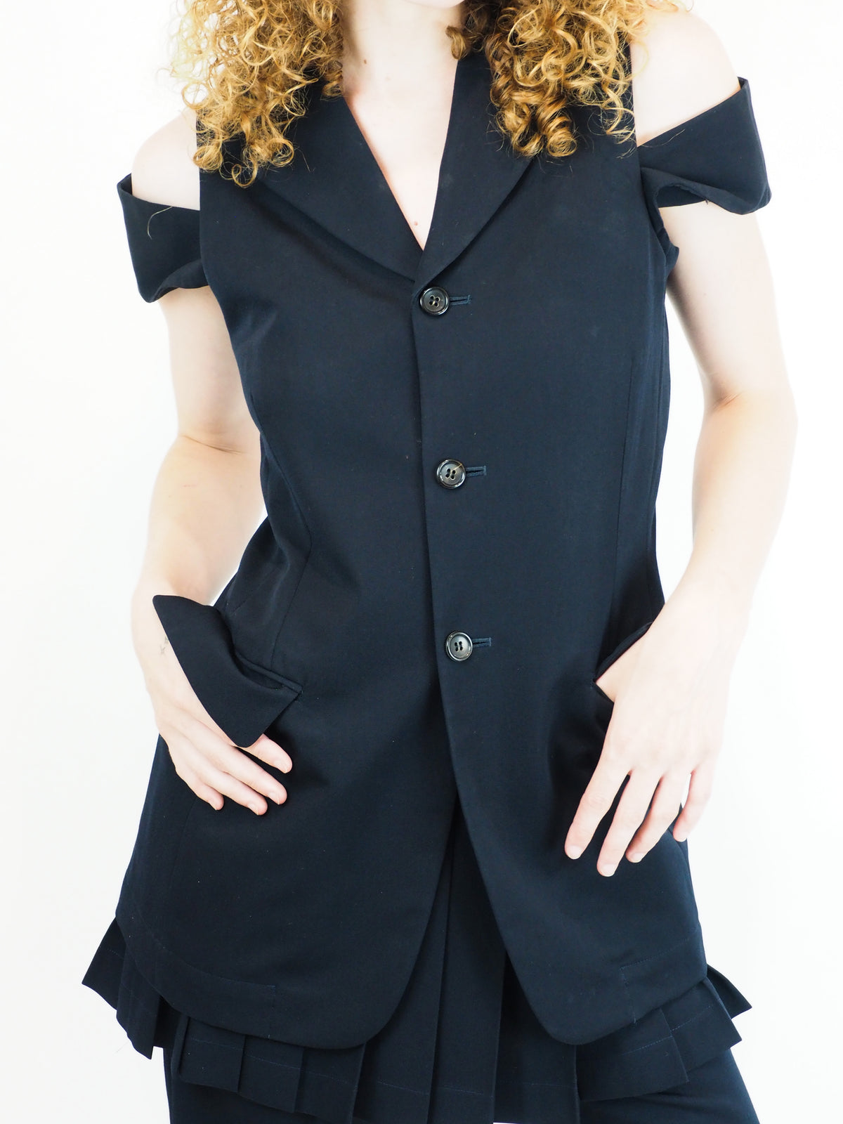 A vintage comme des garçons cold-shoulder blazer with matching navy shorts