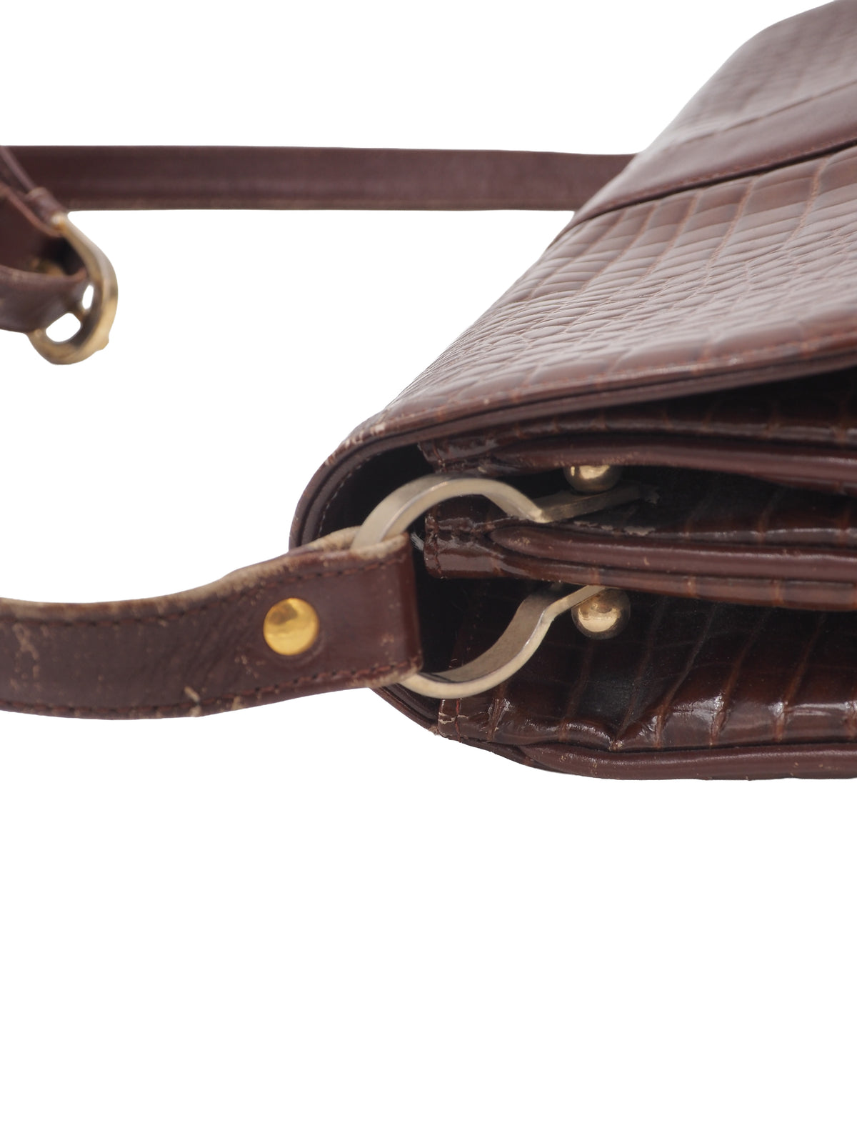 A dark brown courreges vintage crocodile-embossed leather shoulder bag with a matching adjustable strap and a small silver-tone metal logo on the front flap