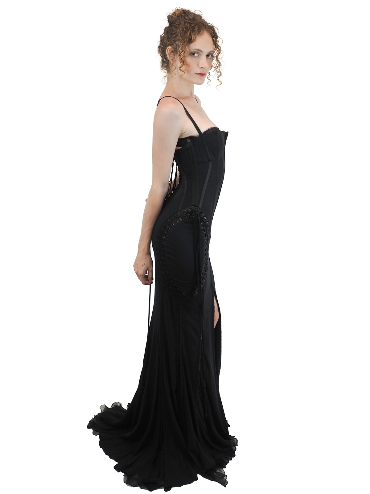 A vintage 2003 dolce and Gabbana long black spaghetti-strap dress with a corset-style bodice, side lace-up details, and a high front slit