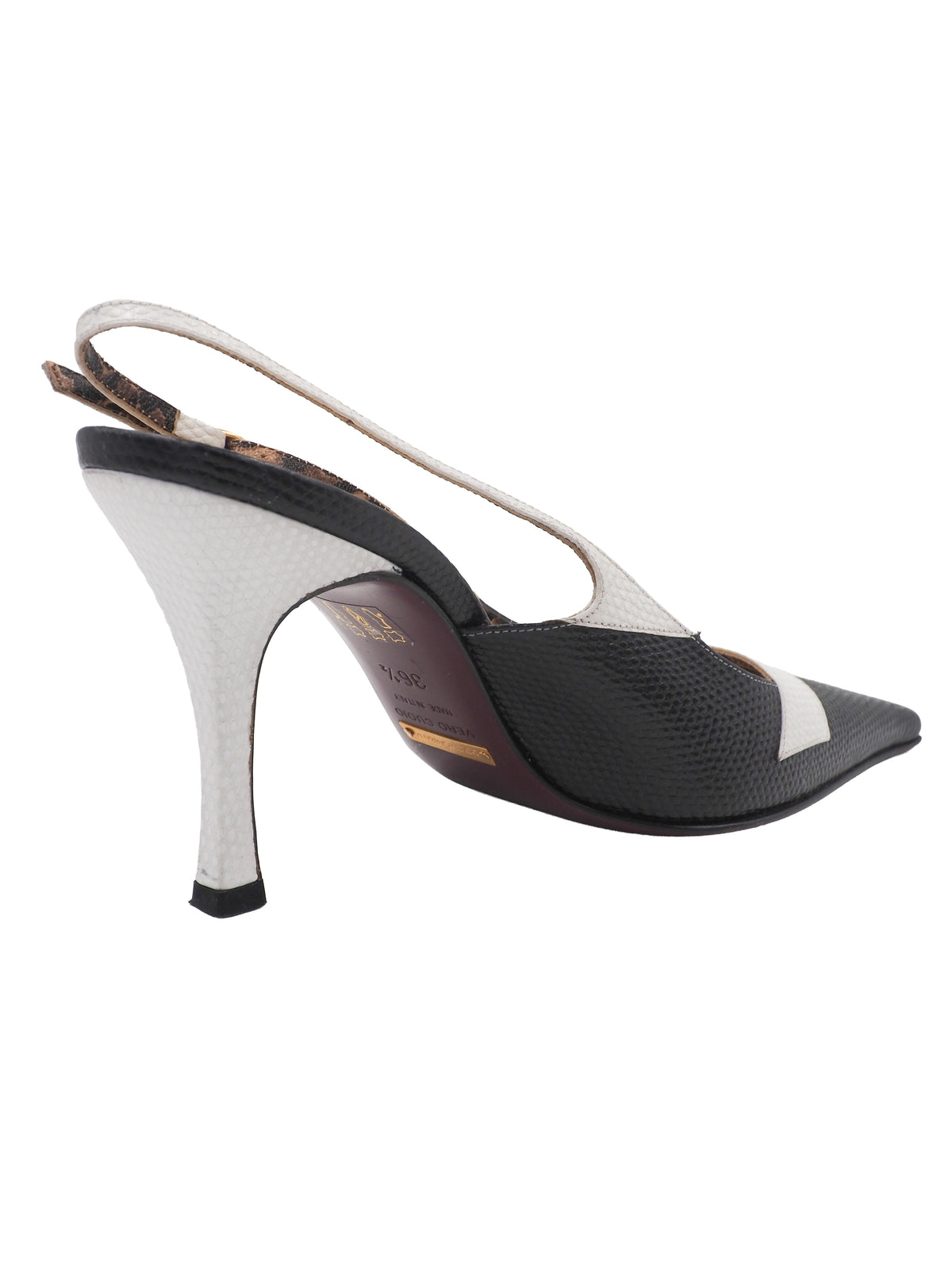 A pair of vintage dolce and Gabbana pointed-toe slingback heels featuring a black textured leather toe, a white midfoot strap with a rhinestone square, and a leopard-print lining