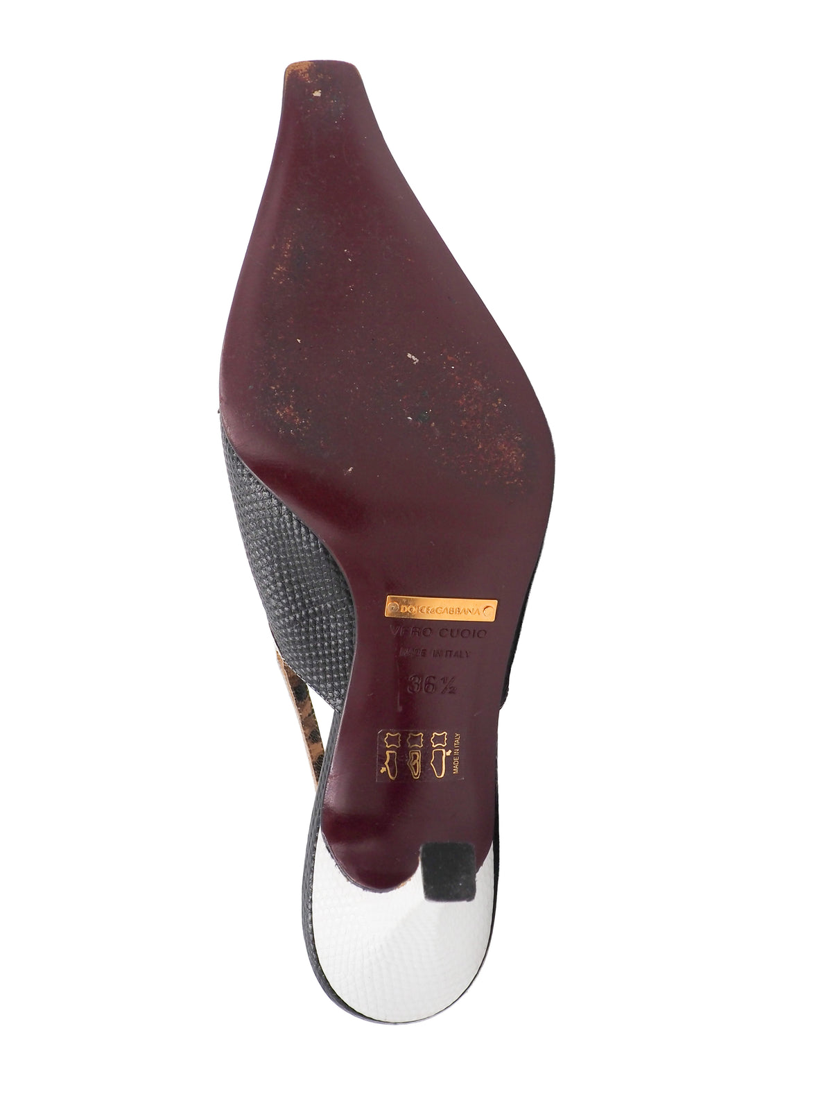 A pair of vintage dolce and Gabbana pointed-toe slingback heels featuring a black textured leather toe, a white midfoot strap with a rhinestone square, and a leopard-print lining