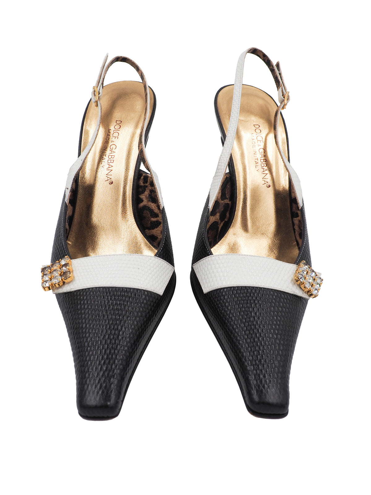 A pair of vintage dolce and Gabbana pointed-toe slingback heels featuring a black textured leather toe, a white midfoot strap with a rhinestone square, and a leopard-print lining