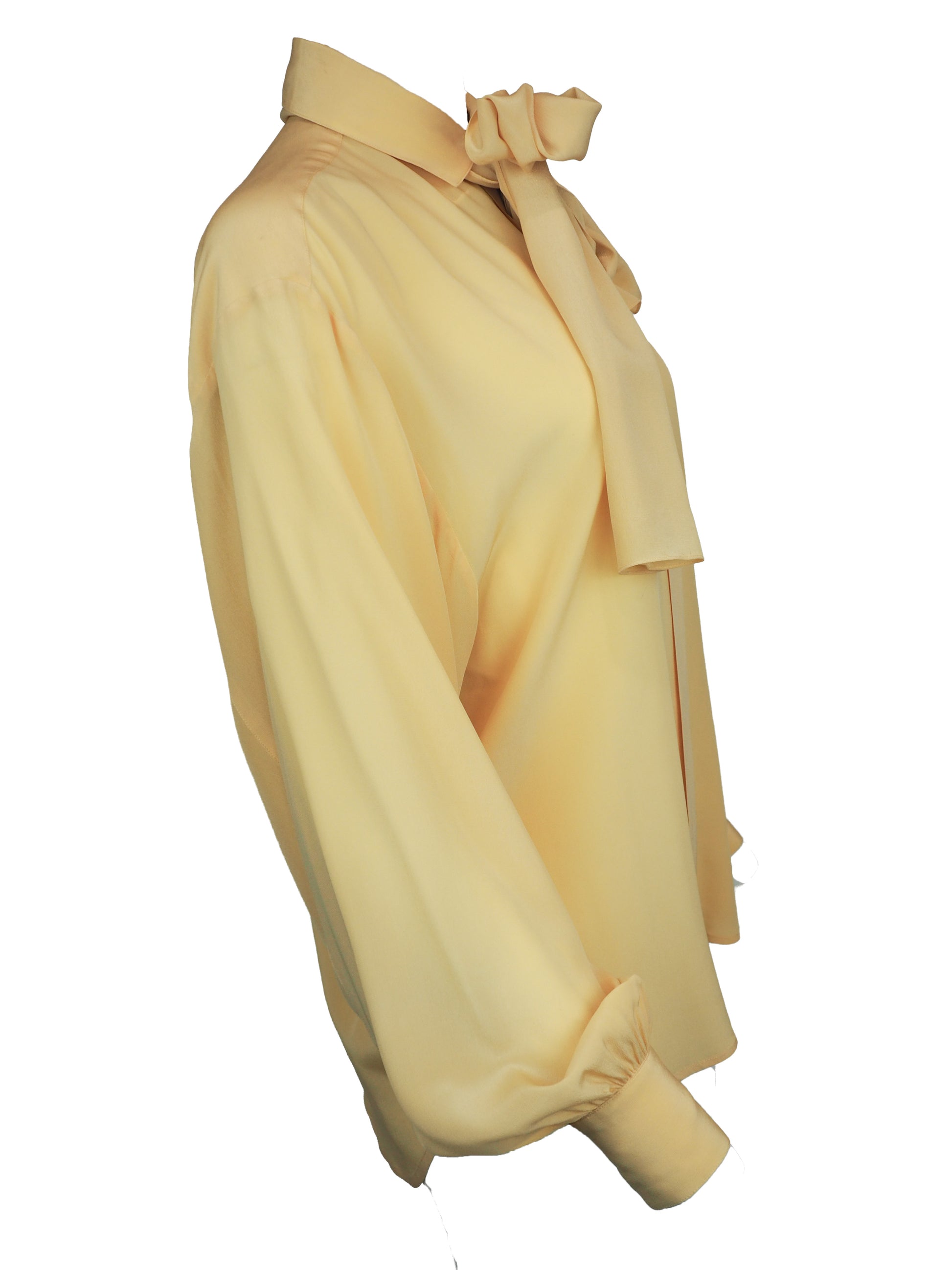 A vintage 1980s Ellen tracy pale yellow long-sleeve blouse with a pointed collar and voluminous balloon sleeves