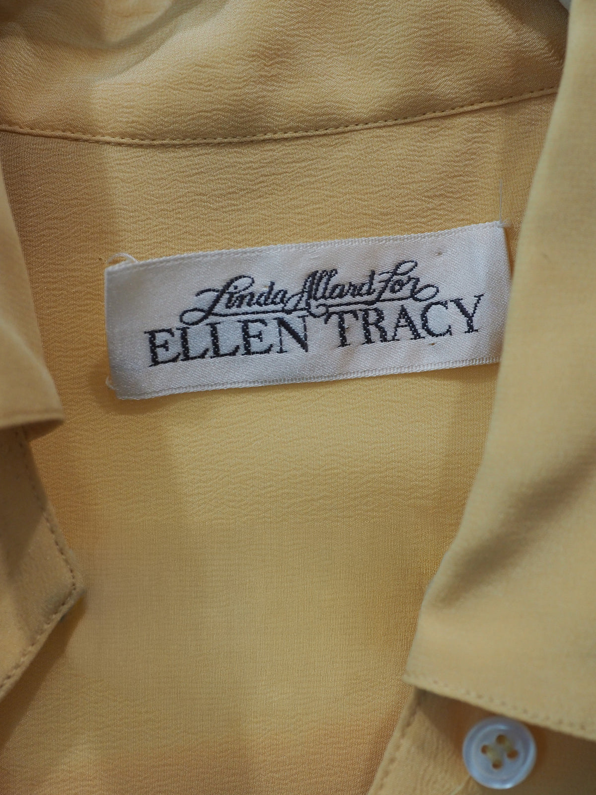 A vintage 1980s Ellen tracy pale yellow long-sleeve blouse with a pointed collar and voluminous balloon sleeves