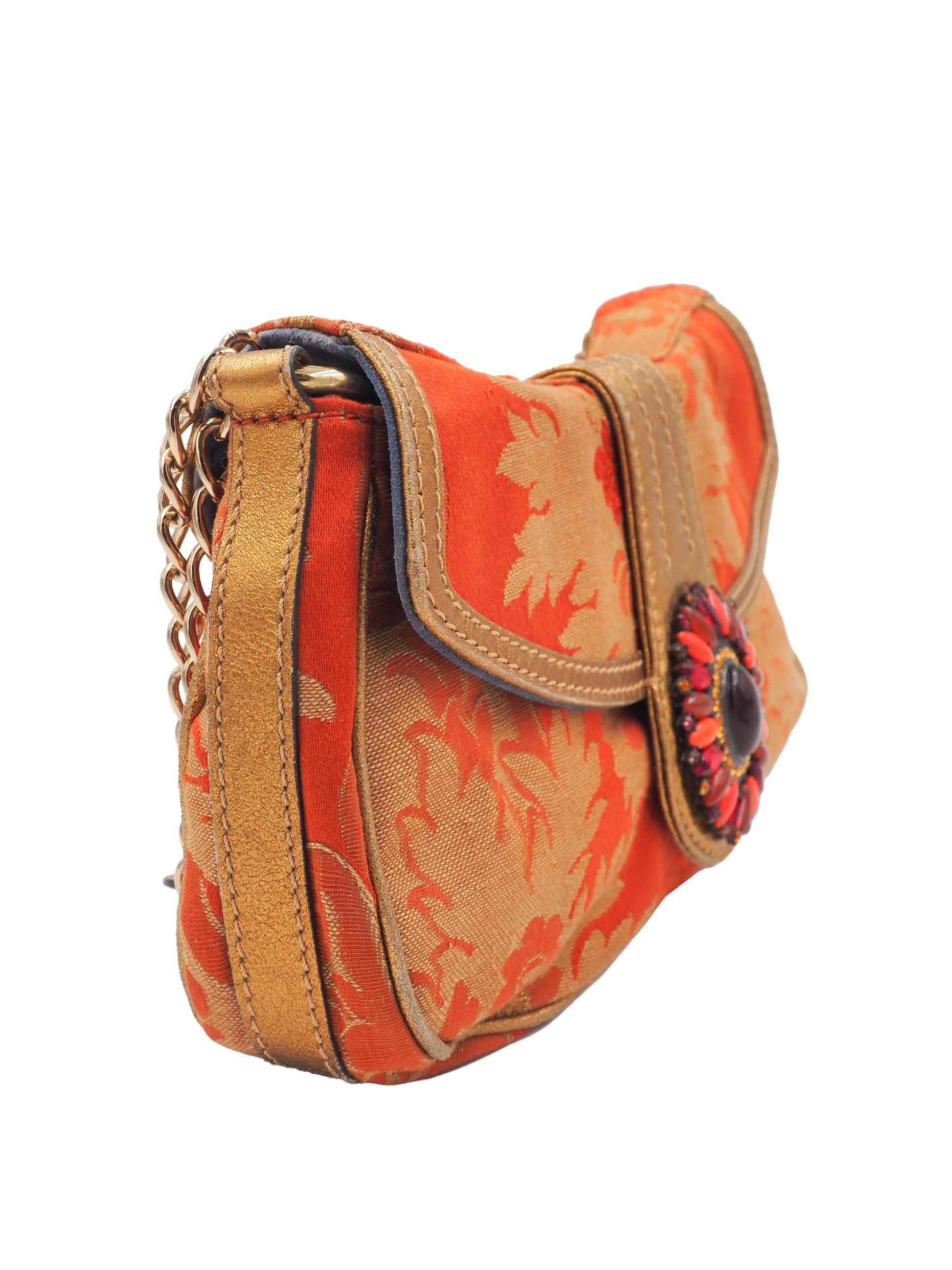 A vintage etro small shoulder bag with a red and gold floral jacquard pattern, featuring a gold-tone chain strap and a decorative red and gold clasp 
