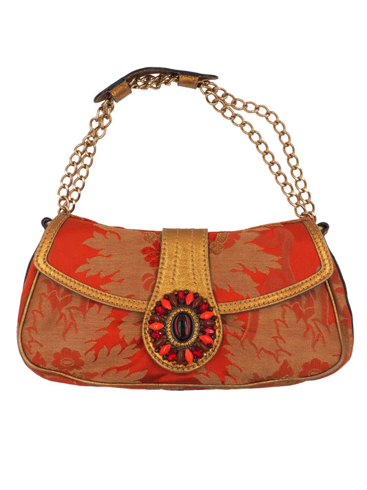 A vintage etro small shoulder bag with a red and gold floral jacquard pattern, featuring a gold-tone chain strap and a decorative red and gold clasp 
