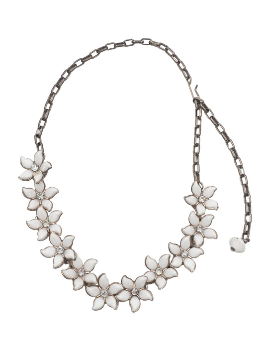 A vintage bridal silver-tone chain necklace featuring a row of white enamel flower blossoms with small clear rhinestone accents