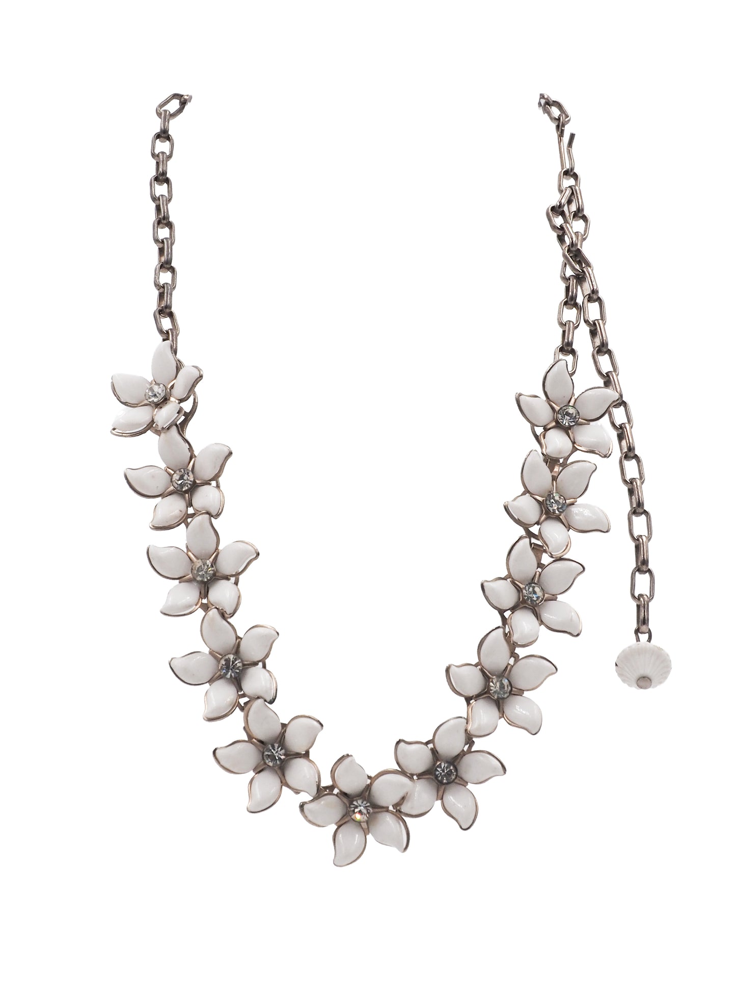 A vintage bridal silver-tone chain necklace featuring a row of white enamel flower blossoms with small clear rhinestone accents