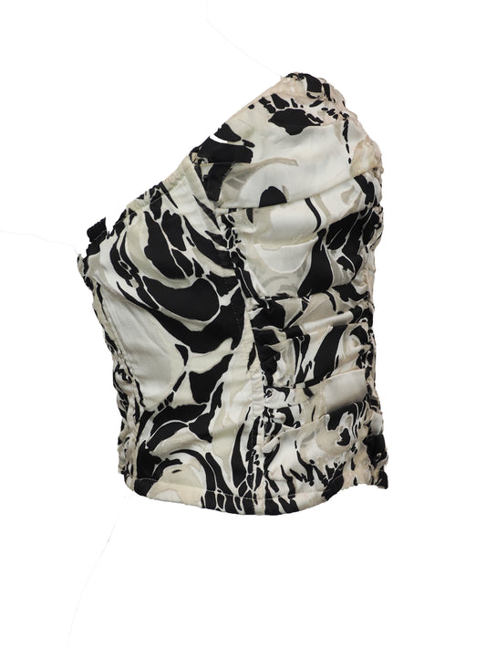 A vintage silk strapless sweetheart bustier top featuring a dramatic black and white abstract marbled pattern with heavy ruffle detailing