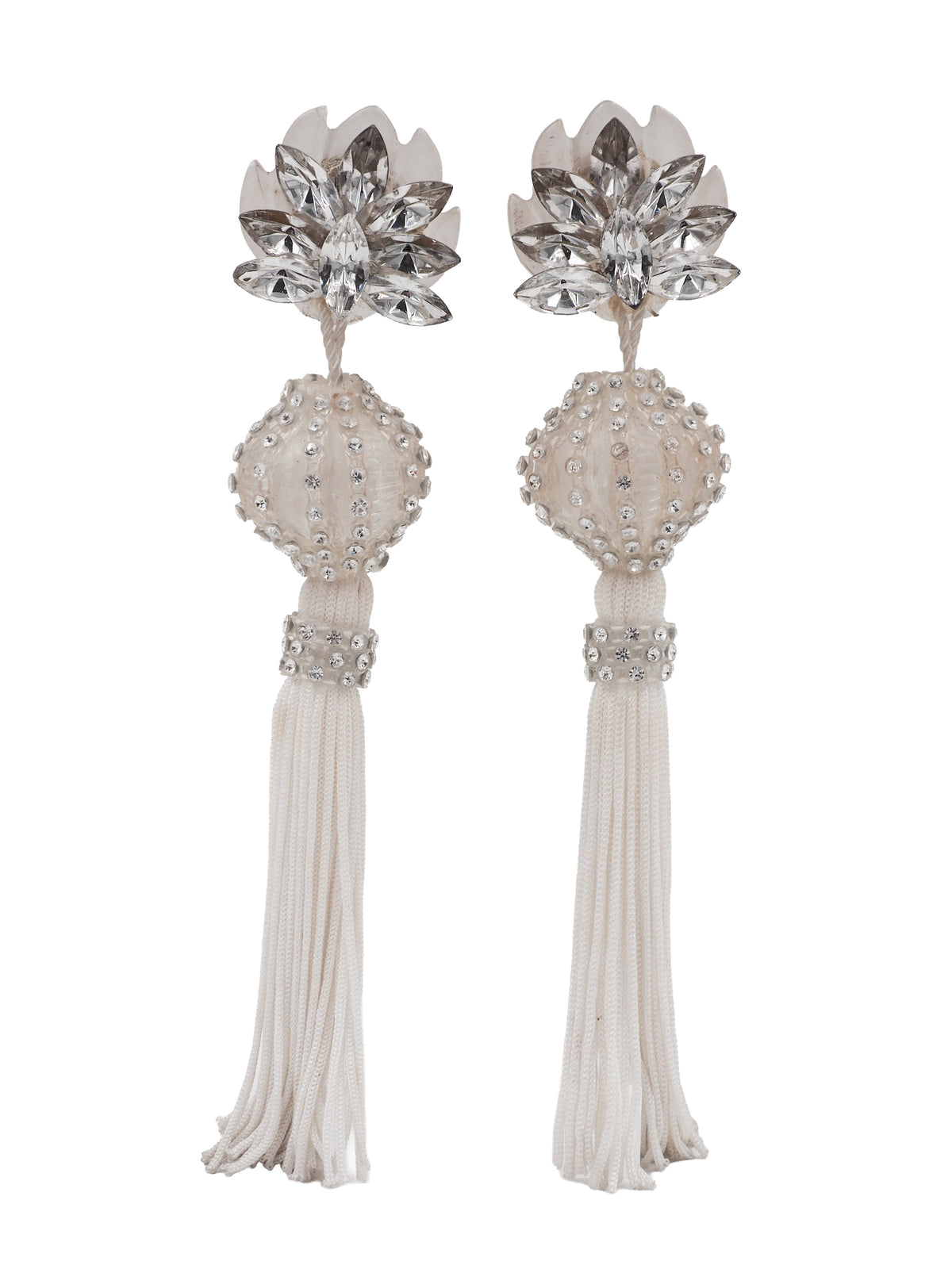 A pair of long, ornate drop earrings with clear faceted crystal flower tops, cream beadwork, and long cream tassel fringe