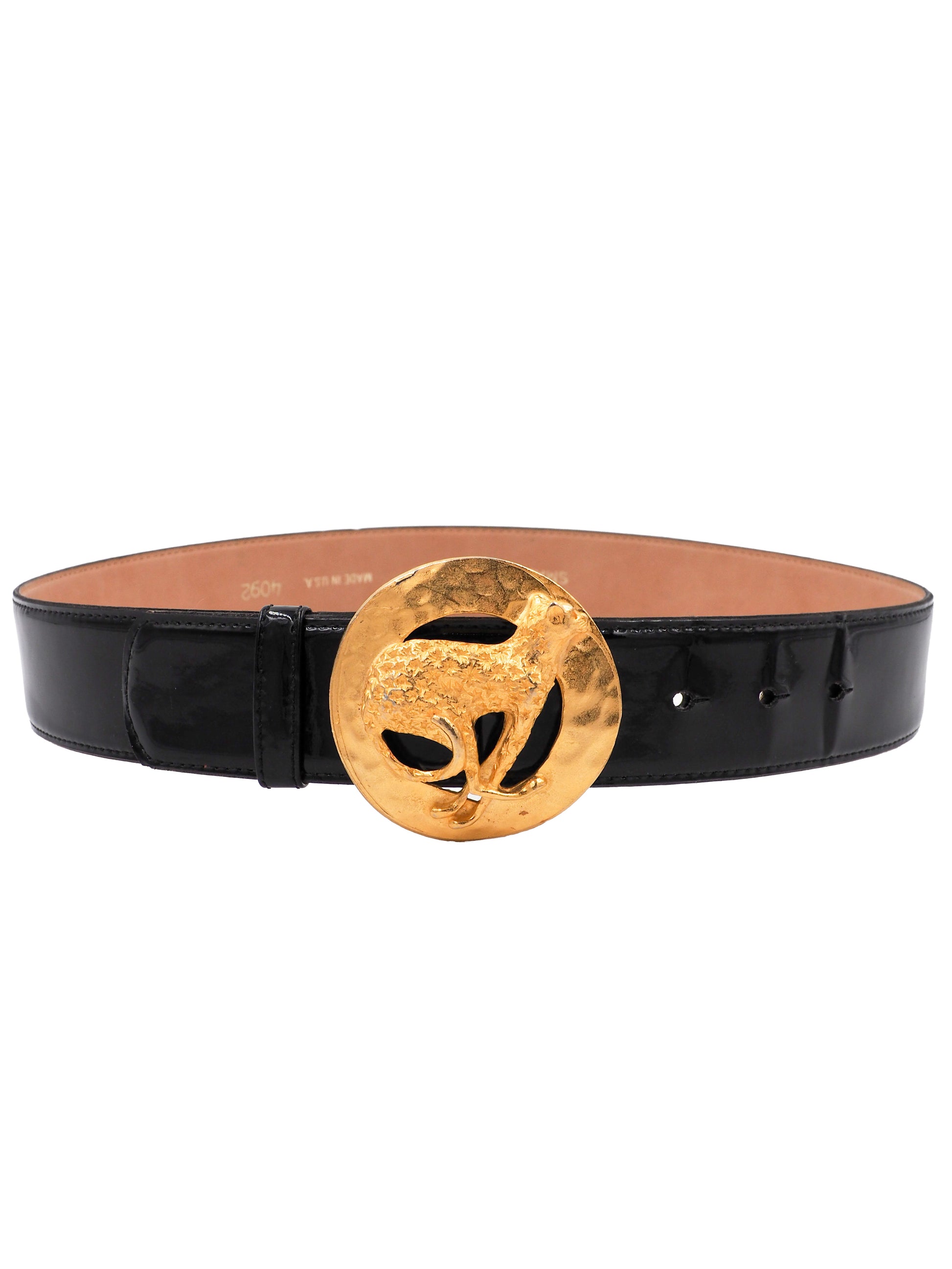 A vintage Gail labelle black leather belt with a large, textured gold buckle featuring a stylized animal motif