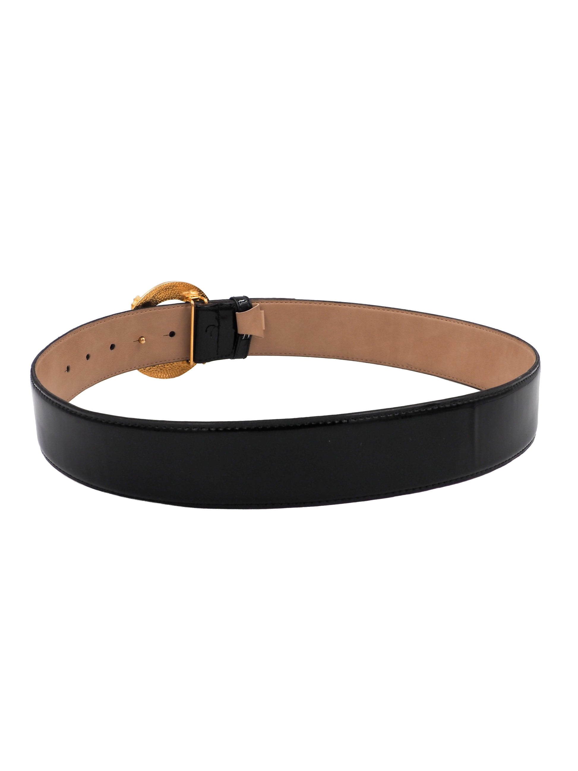 A vintage Gail labelle black leather belt with a large, textured gold buckle featuring a stylized animal motif