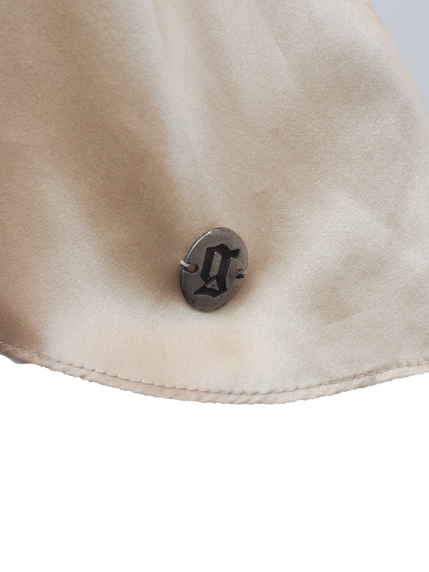 A vintage John galliano Y2K light beige satin camisole top with a V-neckline, thin shoulder straps, a decorative floral embroidered waistband, and pleated detailing on the front