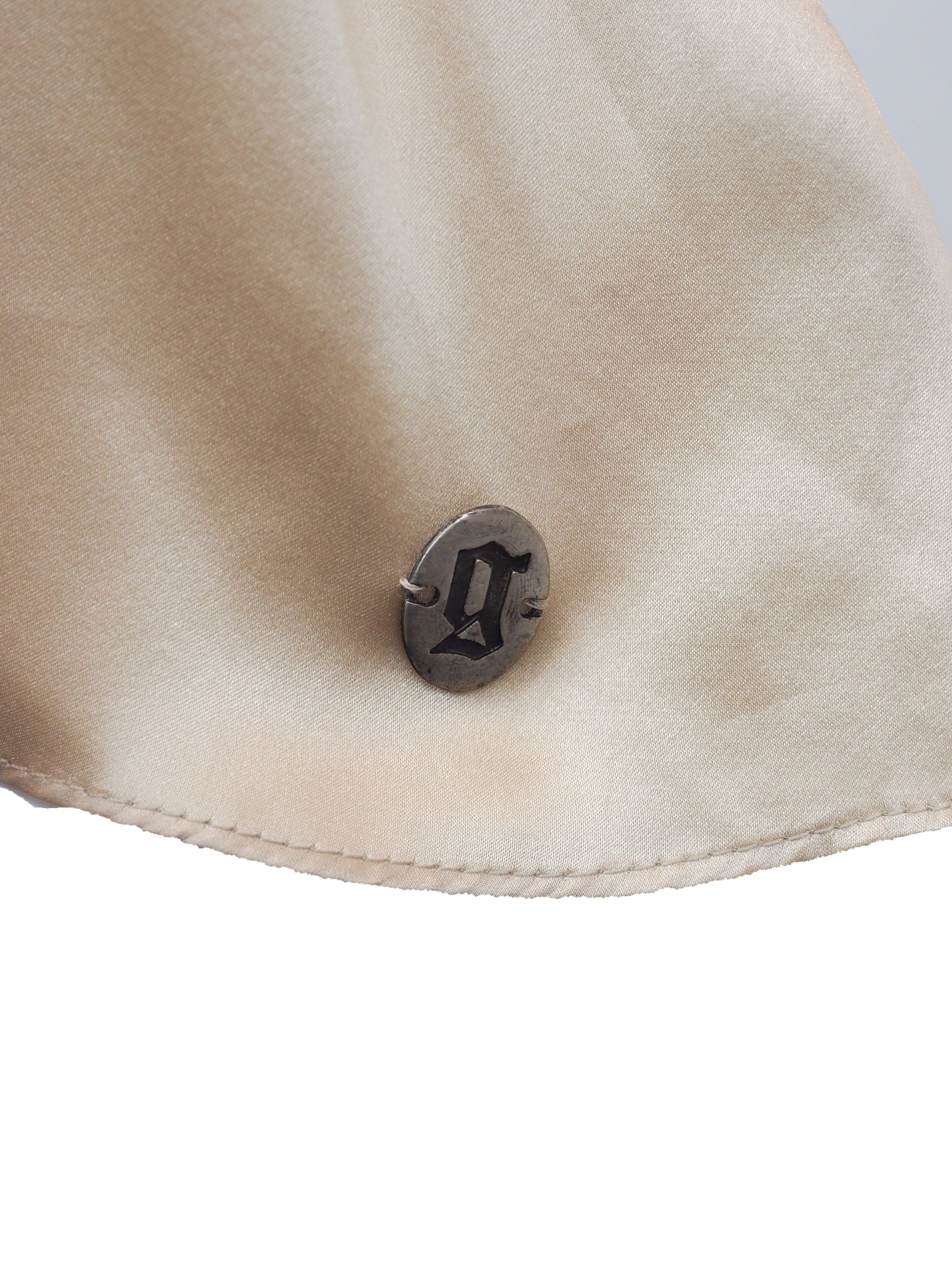 A vintage John galliano Y2K light beige satin camisole top with a V-neckline, thin shoulder straps, a decorative floral embroidered waistband, and pleated detailing on the front