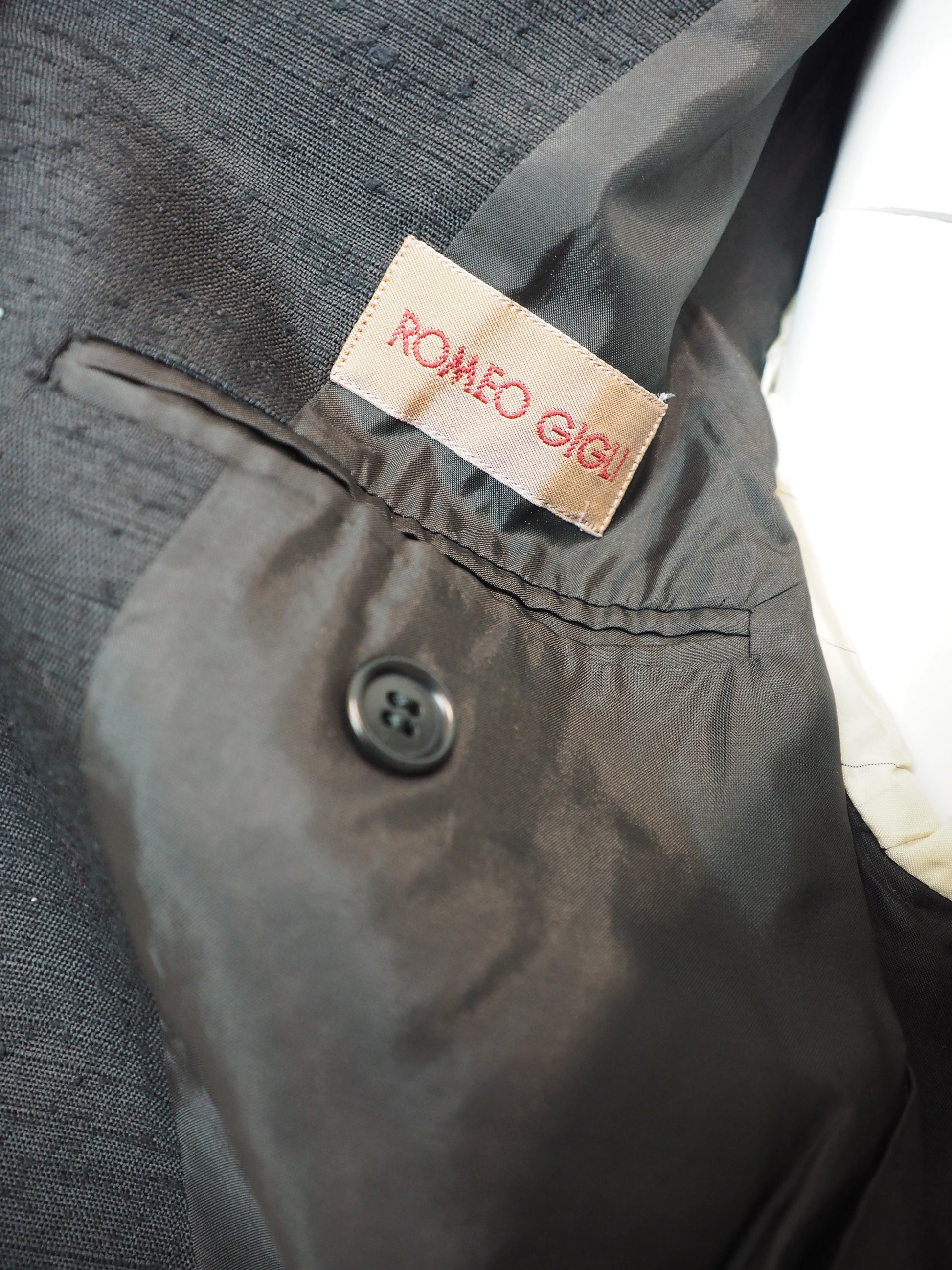 A vintage Romeo gigli dark charcoal gray black  textured jacket with a wide pointed collar, four front buttons, and large front patch pockets